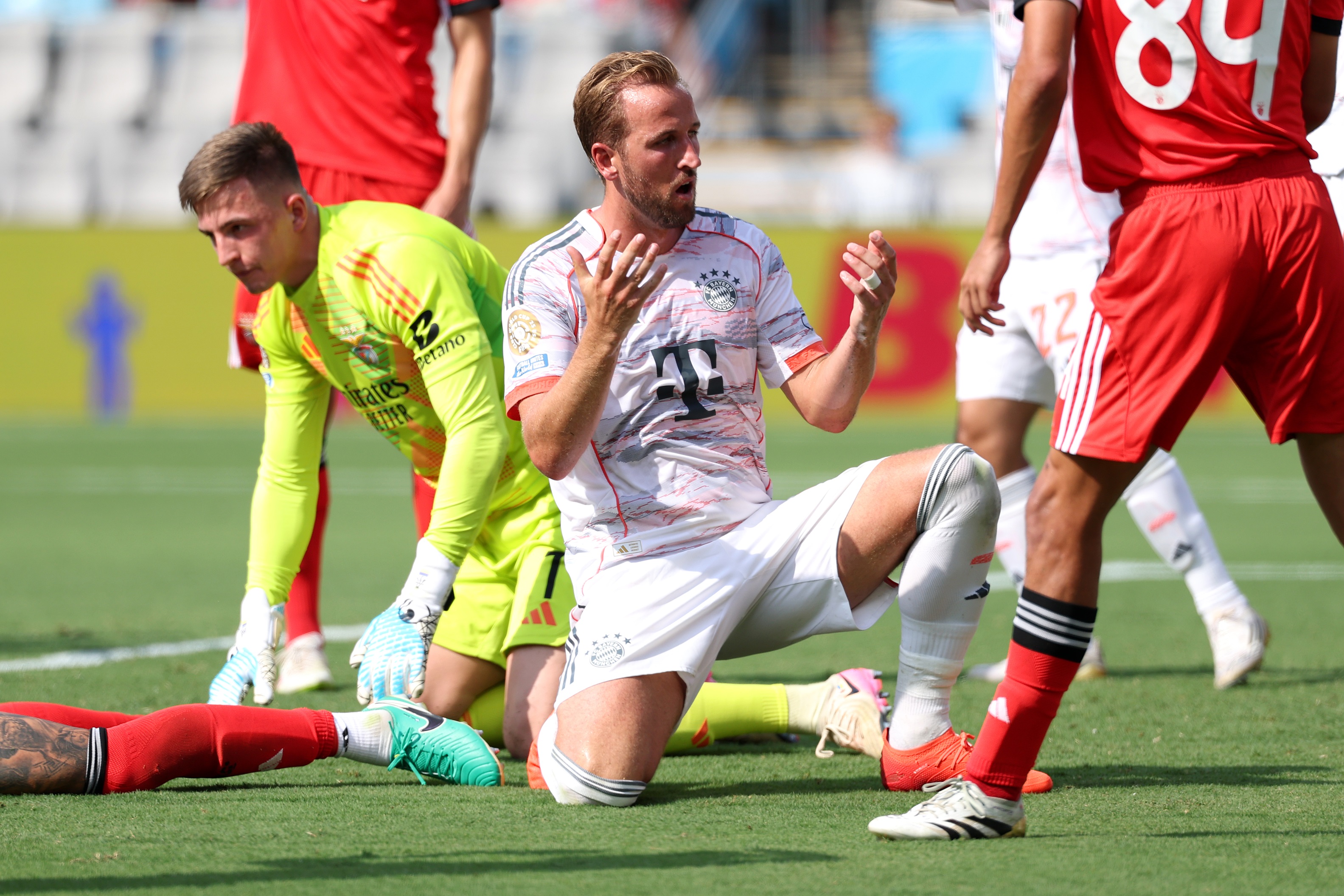 Harry Kane kneels on one knee and throws up his hands in frustration.