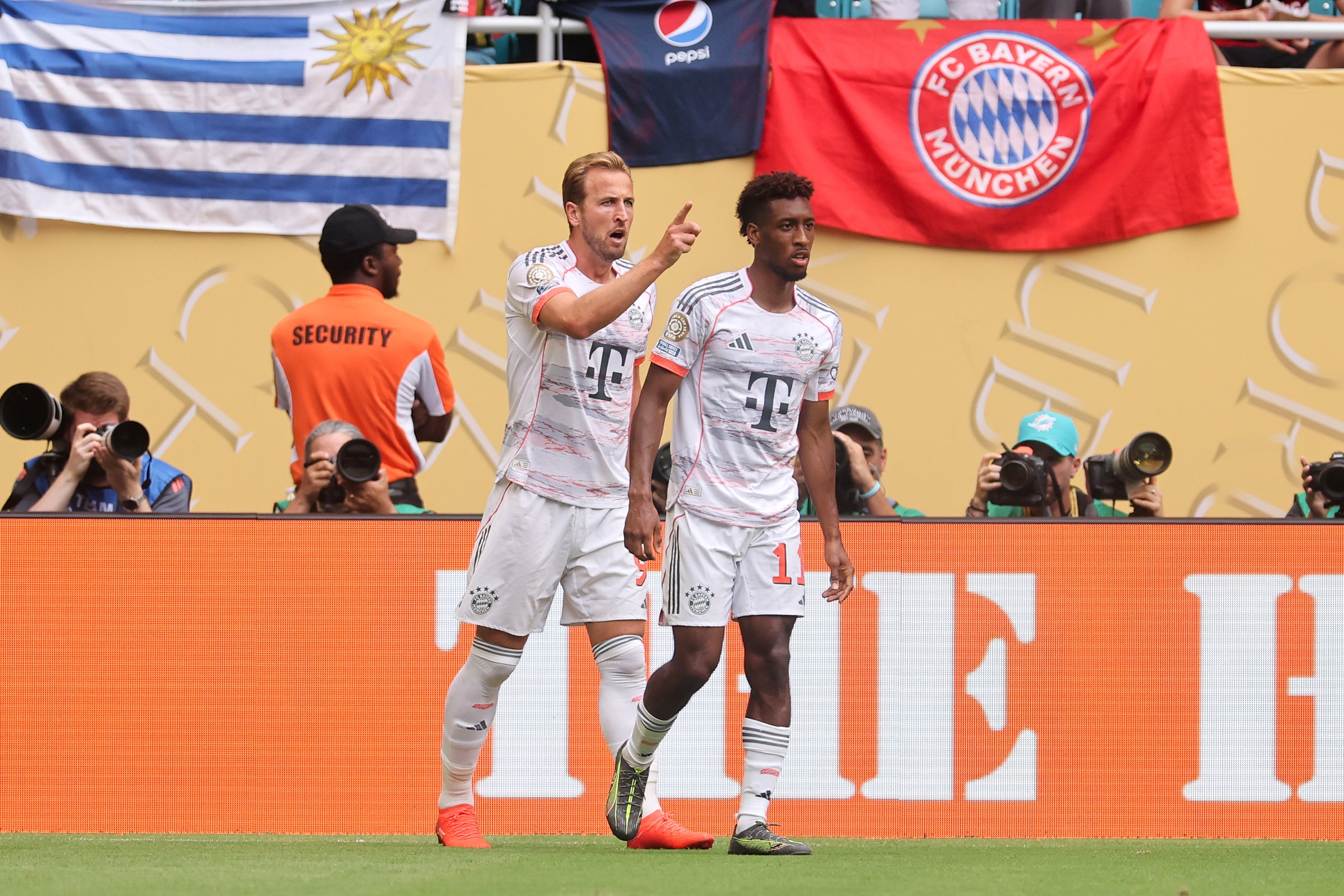 Harry Kane celebrates with Kingsley Coman on the pitch.