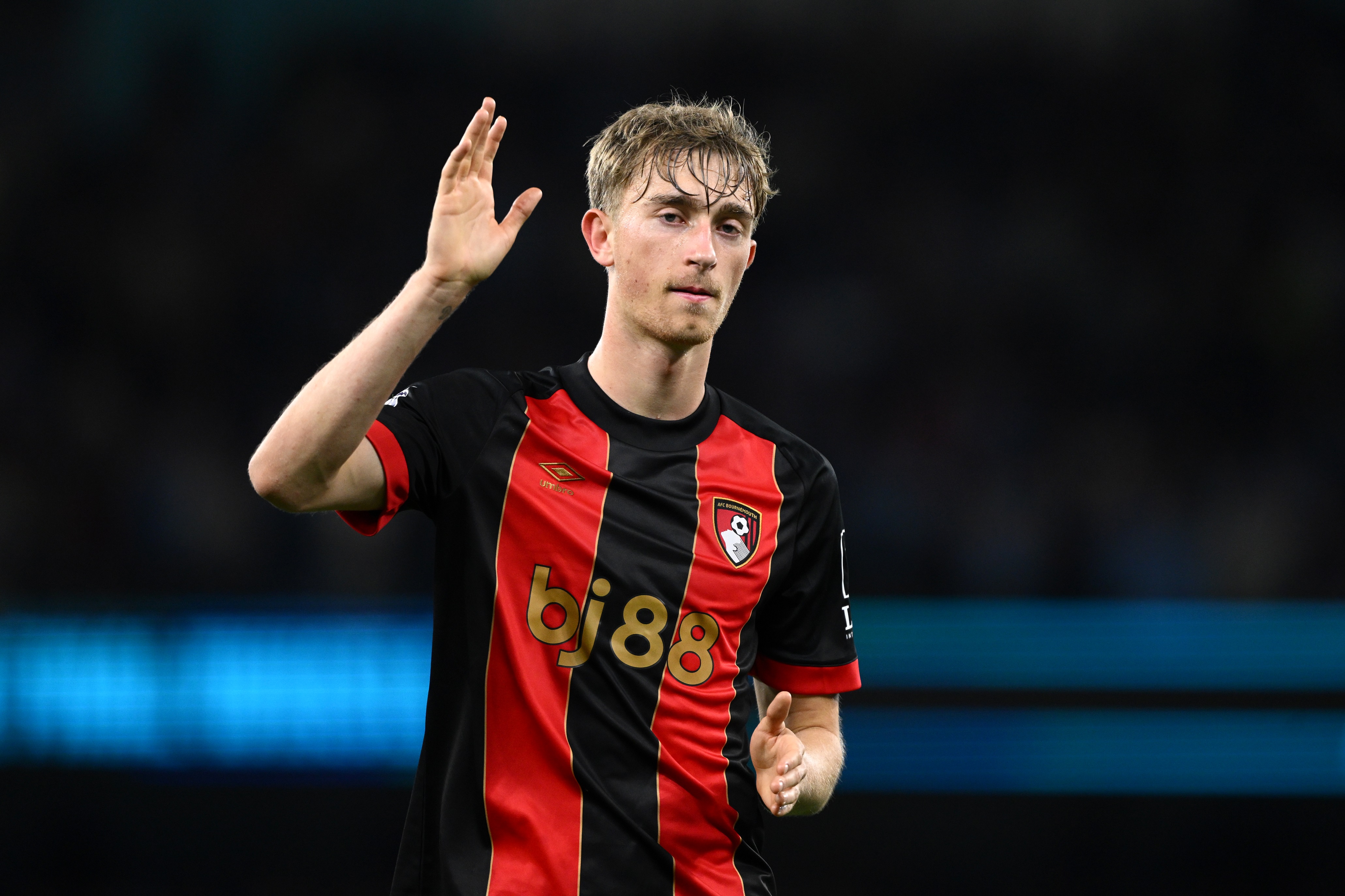 Dean Huijsen waves at Bournemouth fans during Premier League game.