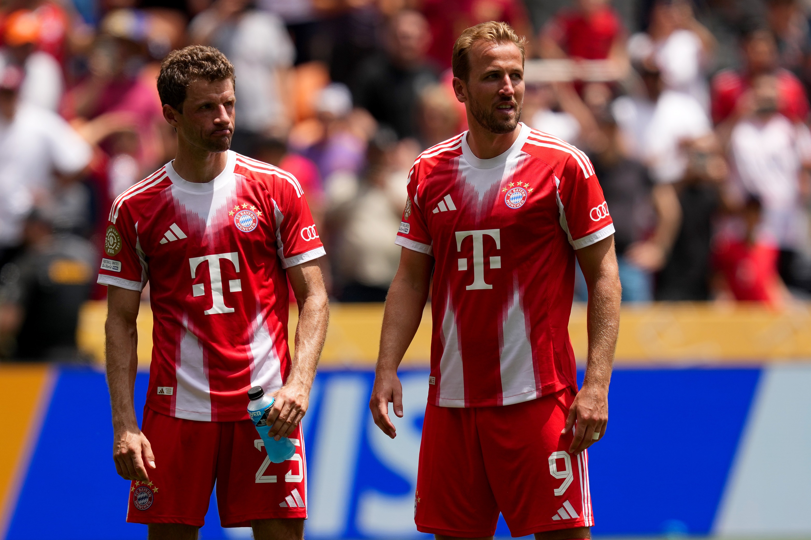 Thomas Muller and Harry Kane stand side by side on the pitch.