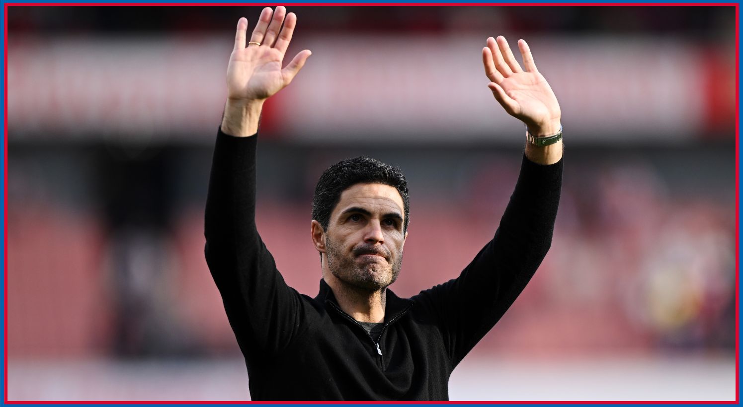 Mikel Arteta waves his hands towards fans