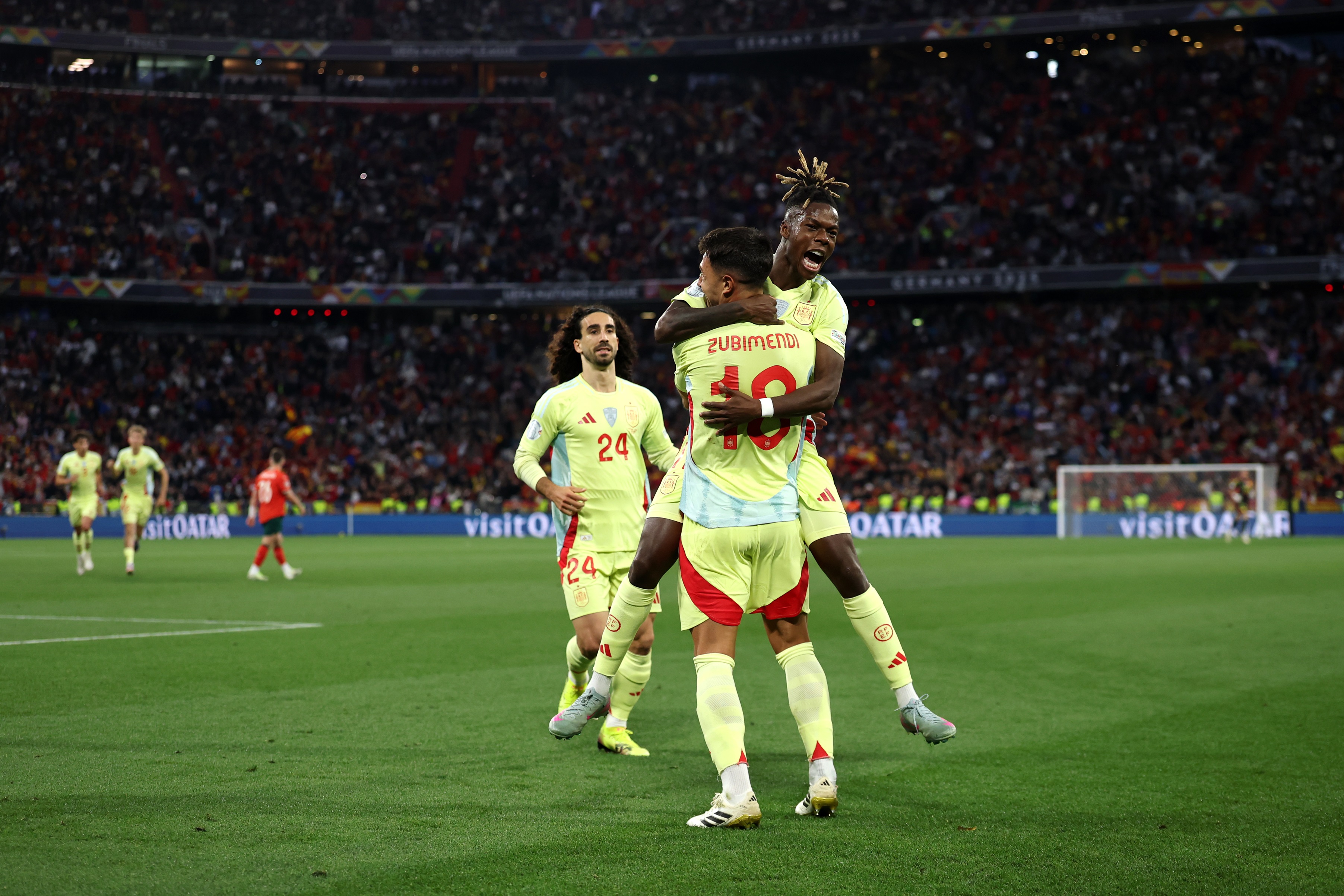 Nico Williams jumps on Martin Zubimendi during Spain game.