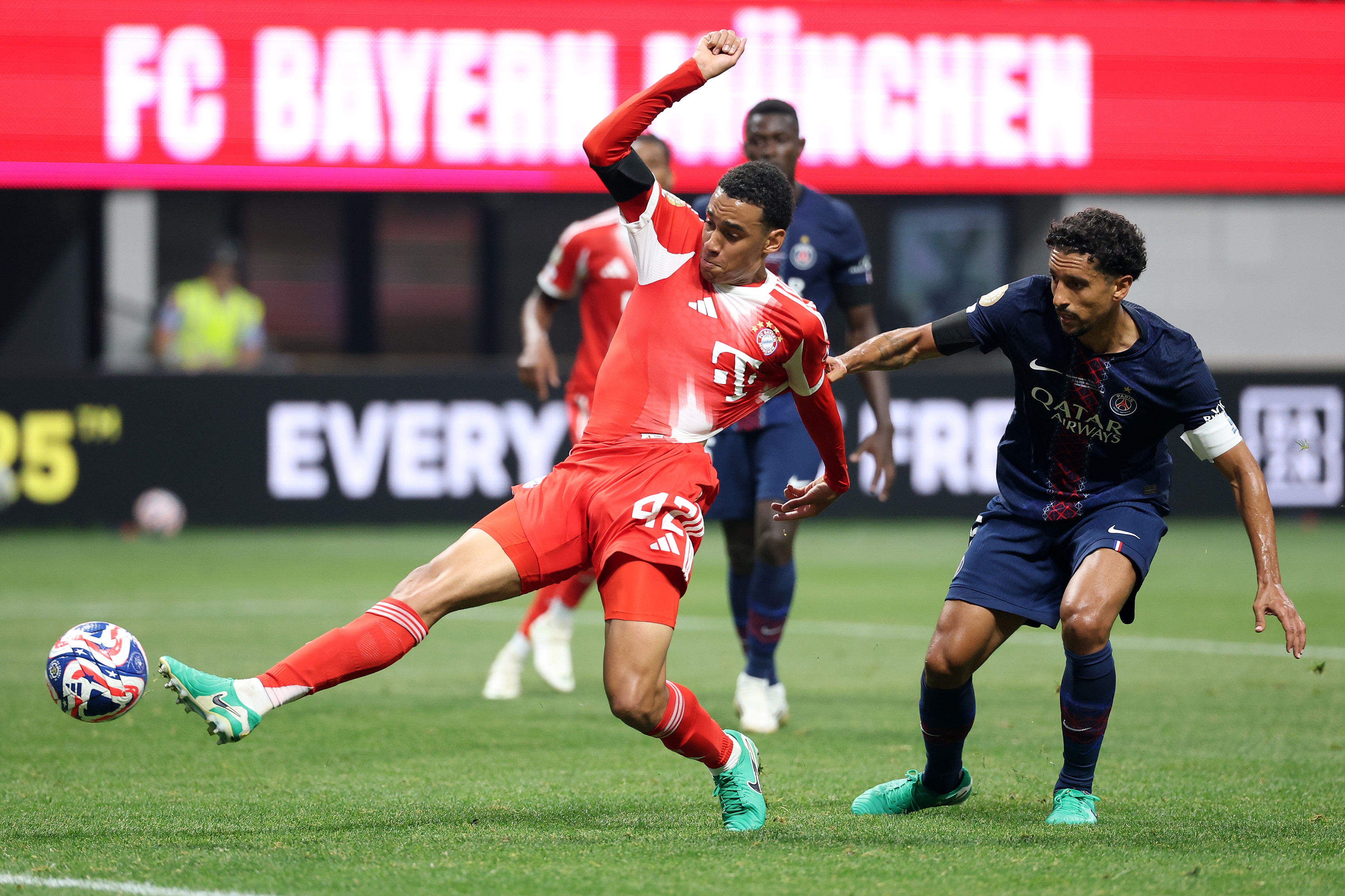 Jamal Musiala lunges for the ball under pressure.