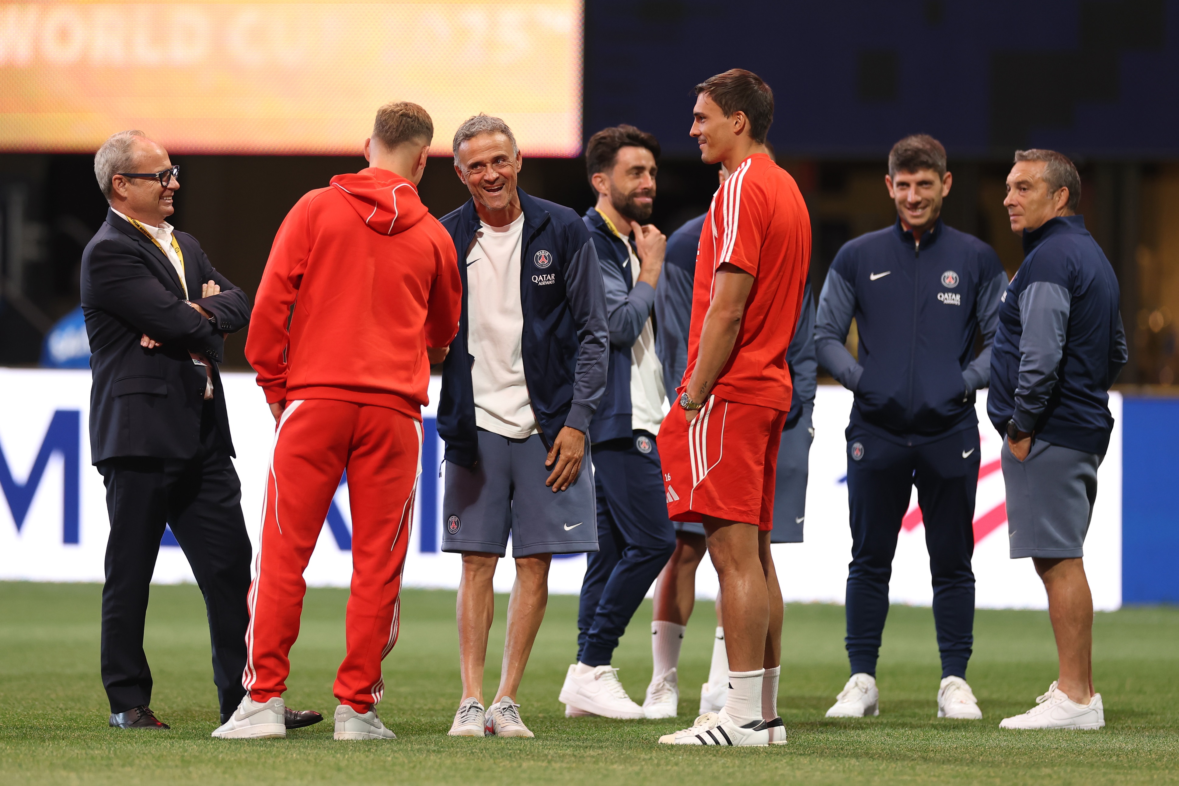 Joao Palhinha speaks with Luis Enrique on the pitch.