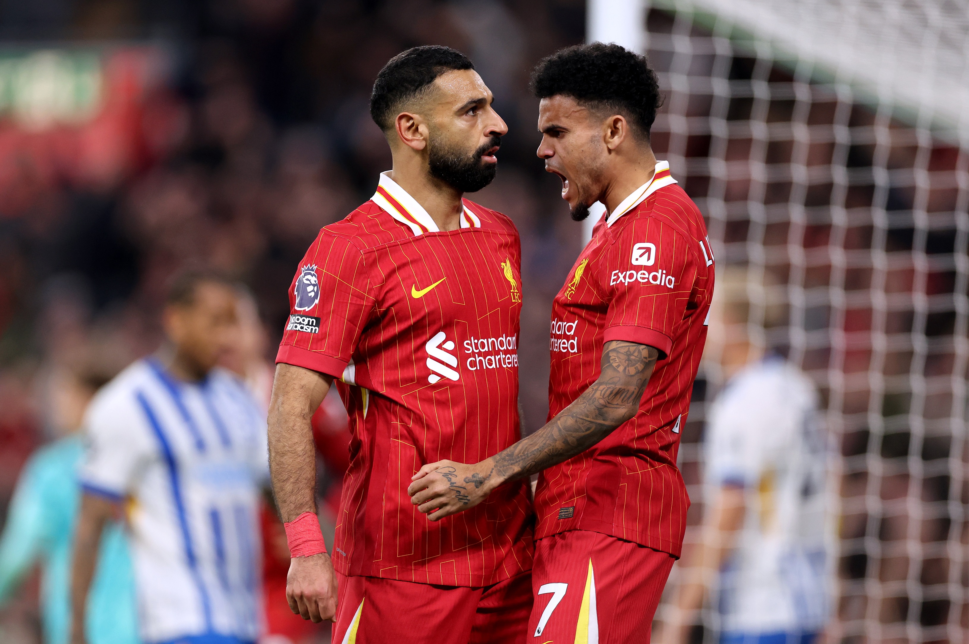 Luis Diaz screams as he celebrates with Mo Salah.