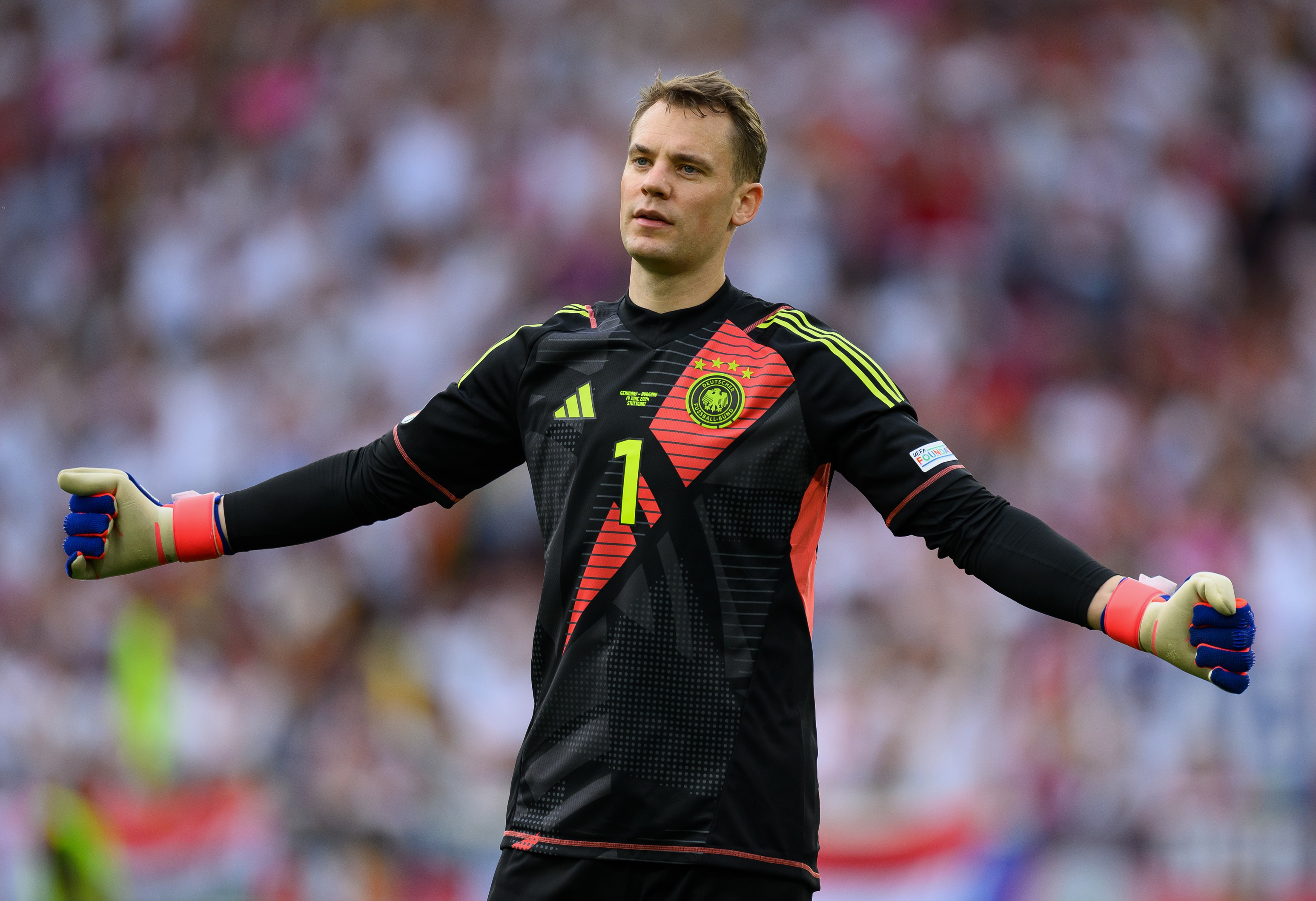 Manuel Neuer holds his arms outstretched wide.