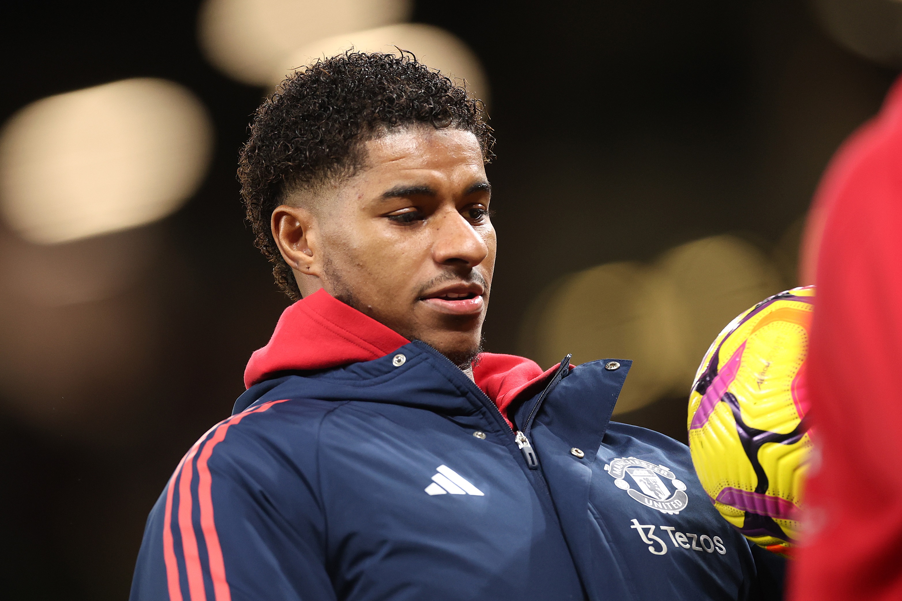 Marcus Rashford looks down at a ball he's controlling.