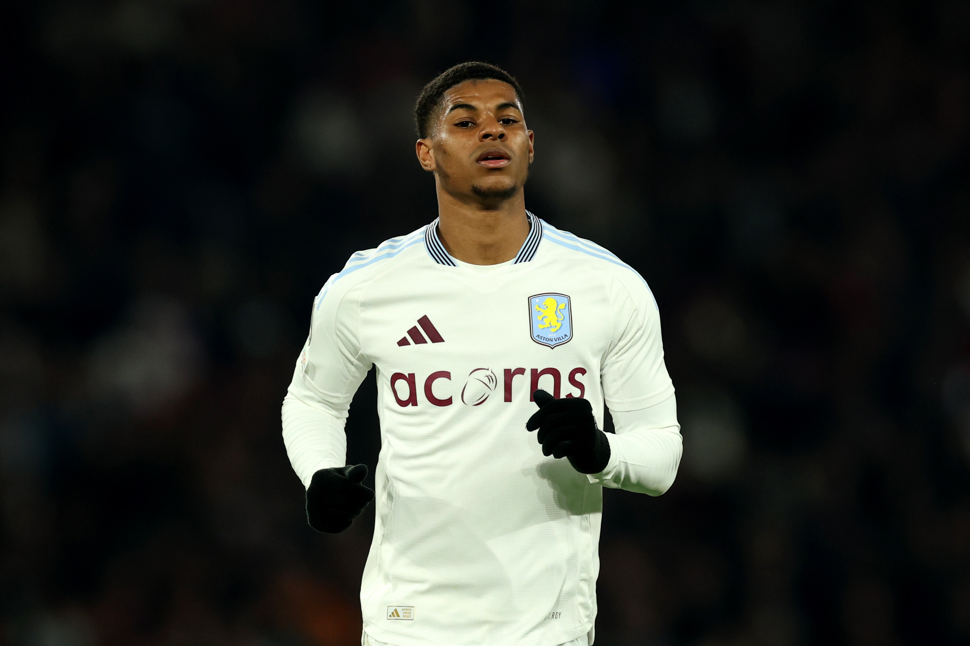 Marcus Rashford runs in an Aston Villa shirt.