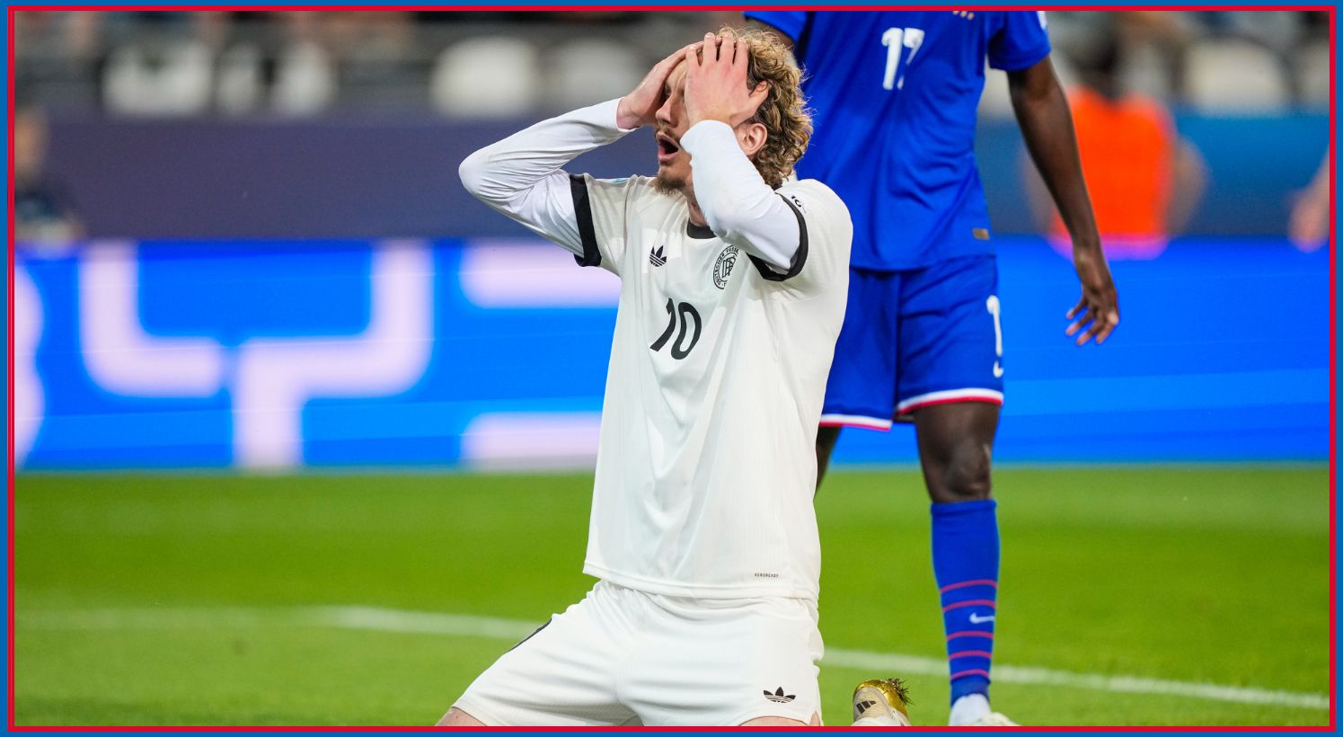 Nick Woltemade on his knees with both hands on his head.