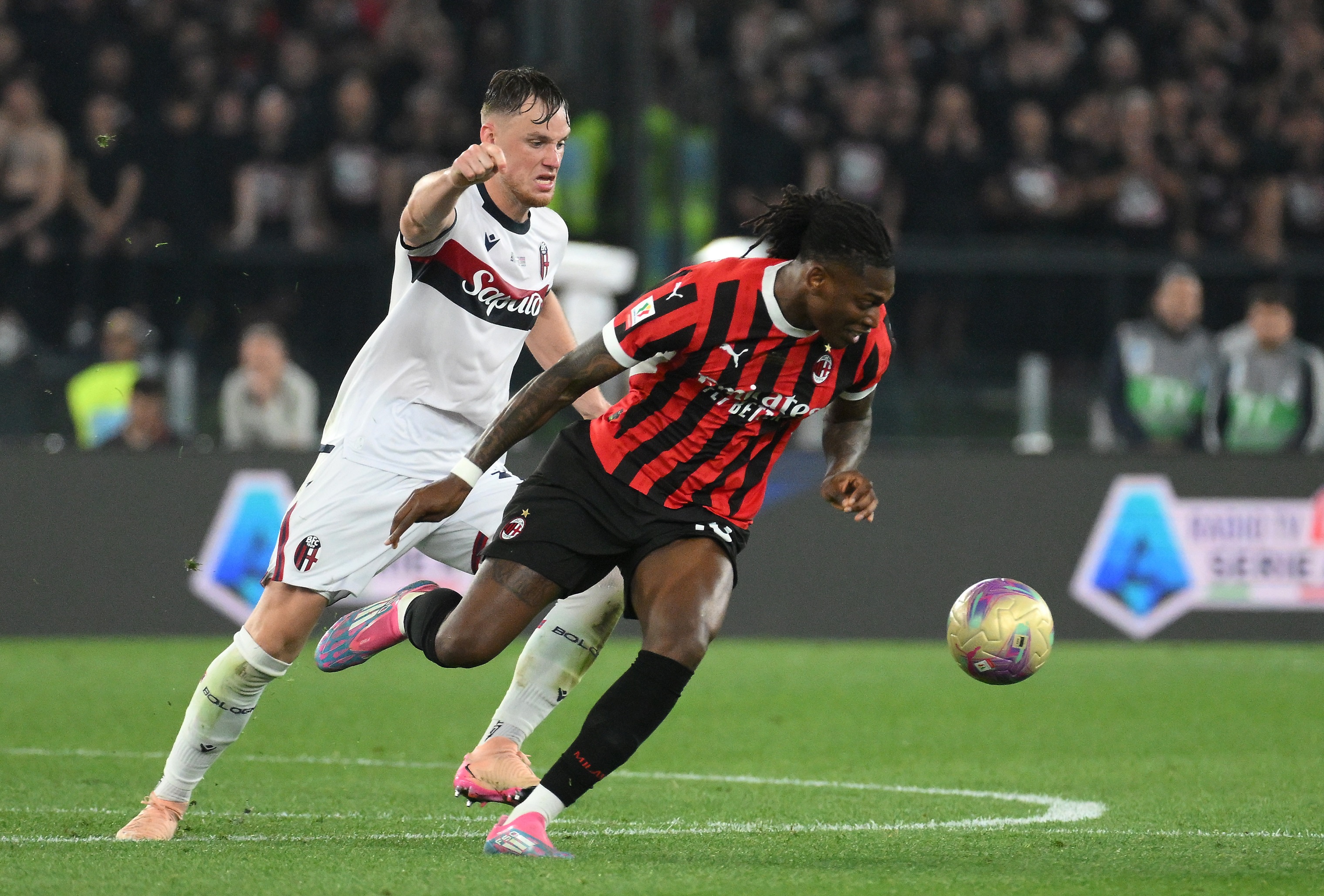 Rafael Leao dribbles away from Bologna's Remo Freuler.