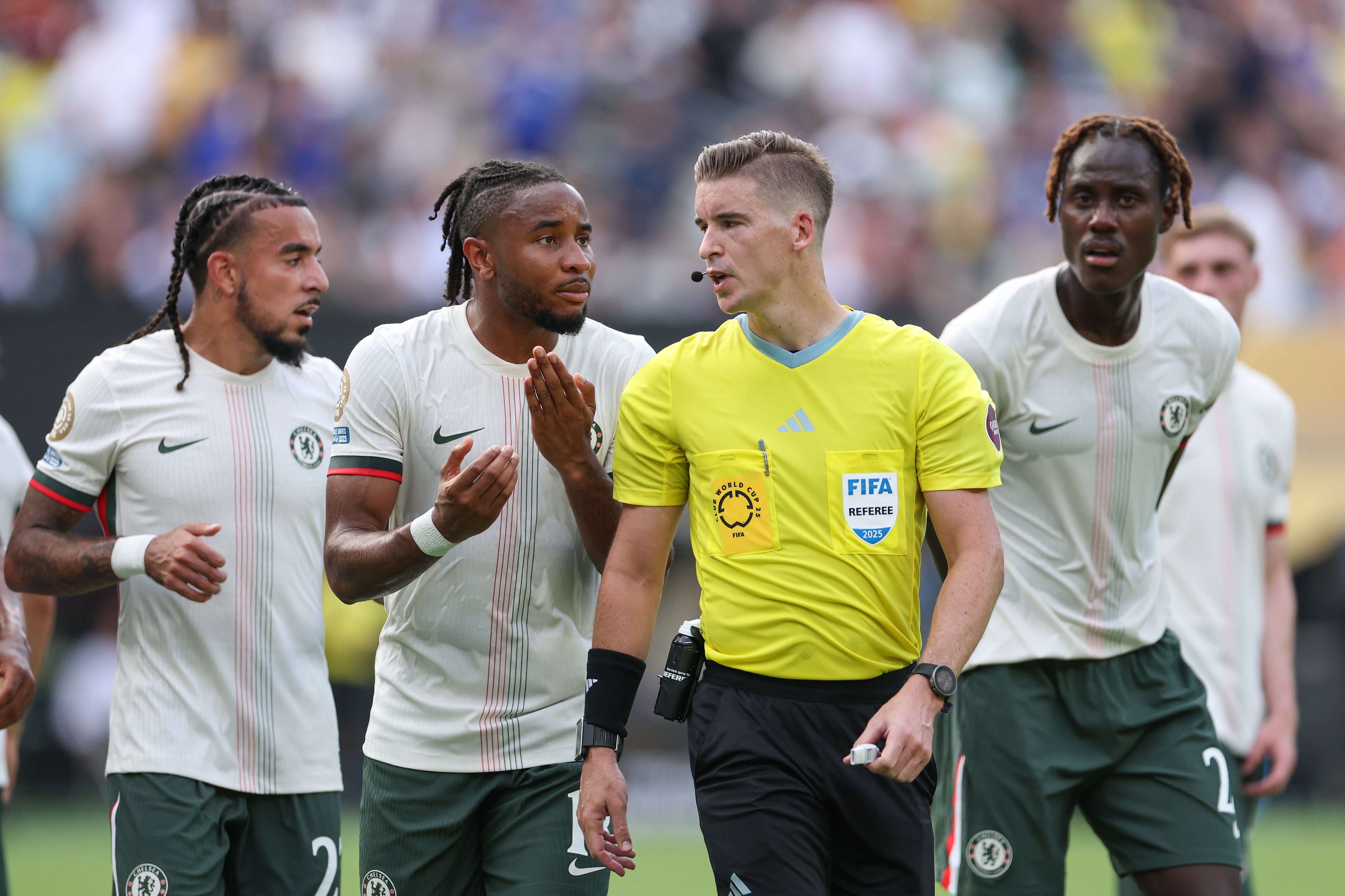 Christopher Nkunku gestures with his hands whilst speaking to the referee.