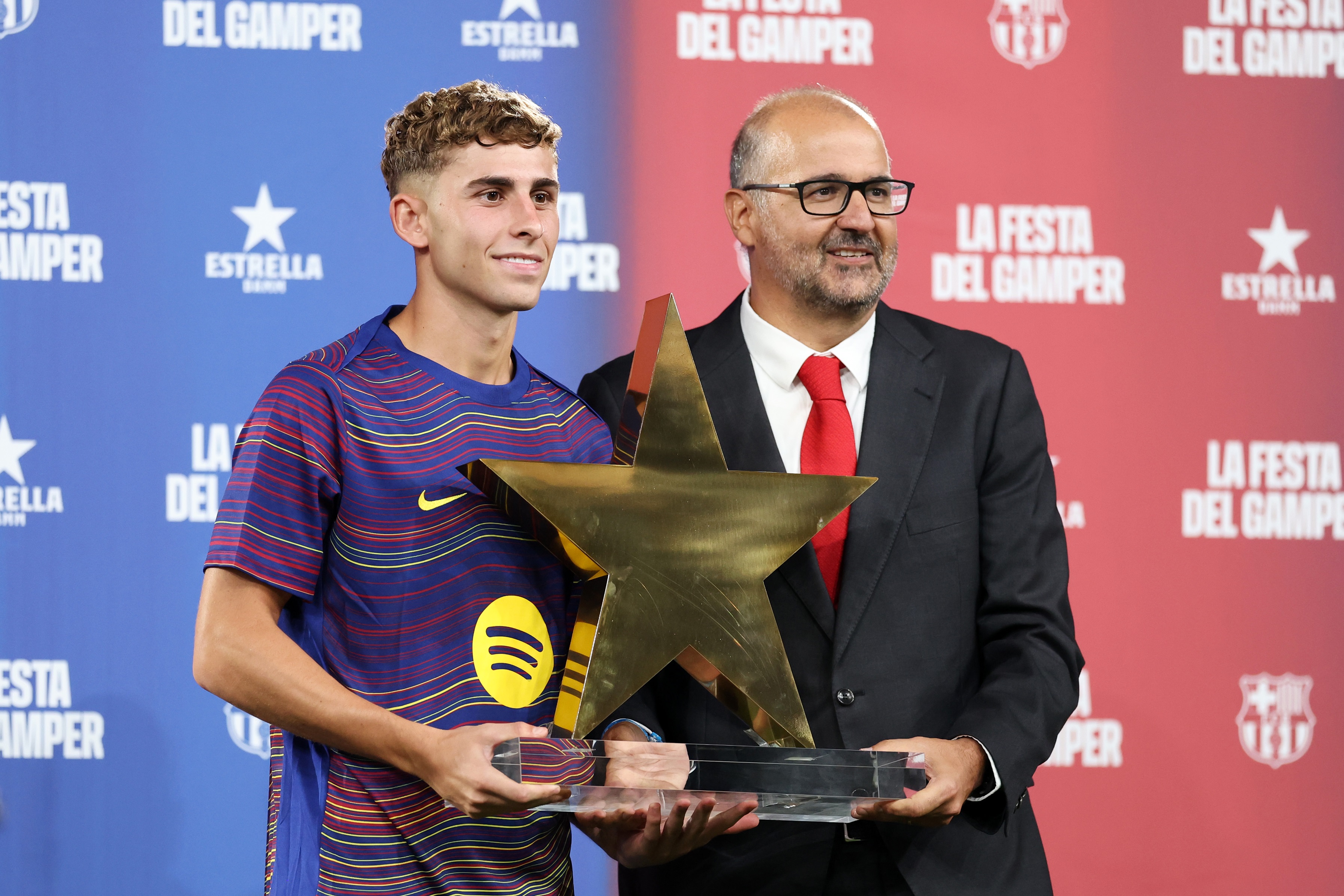 Fermin Lopez holds an award shaped like a star.