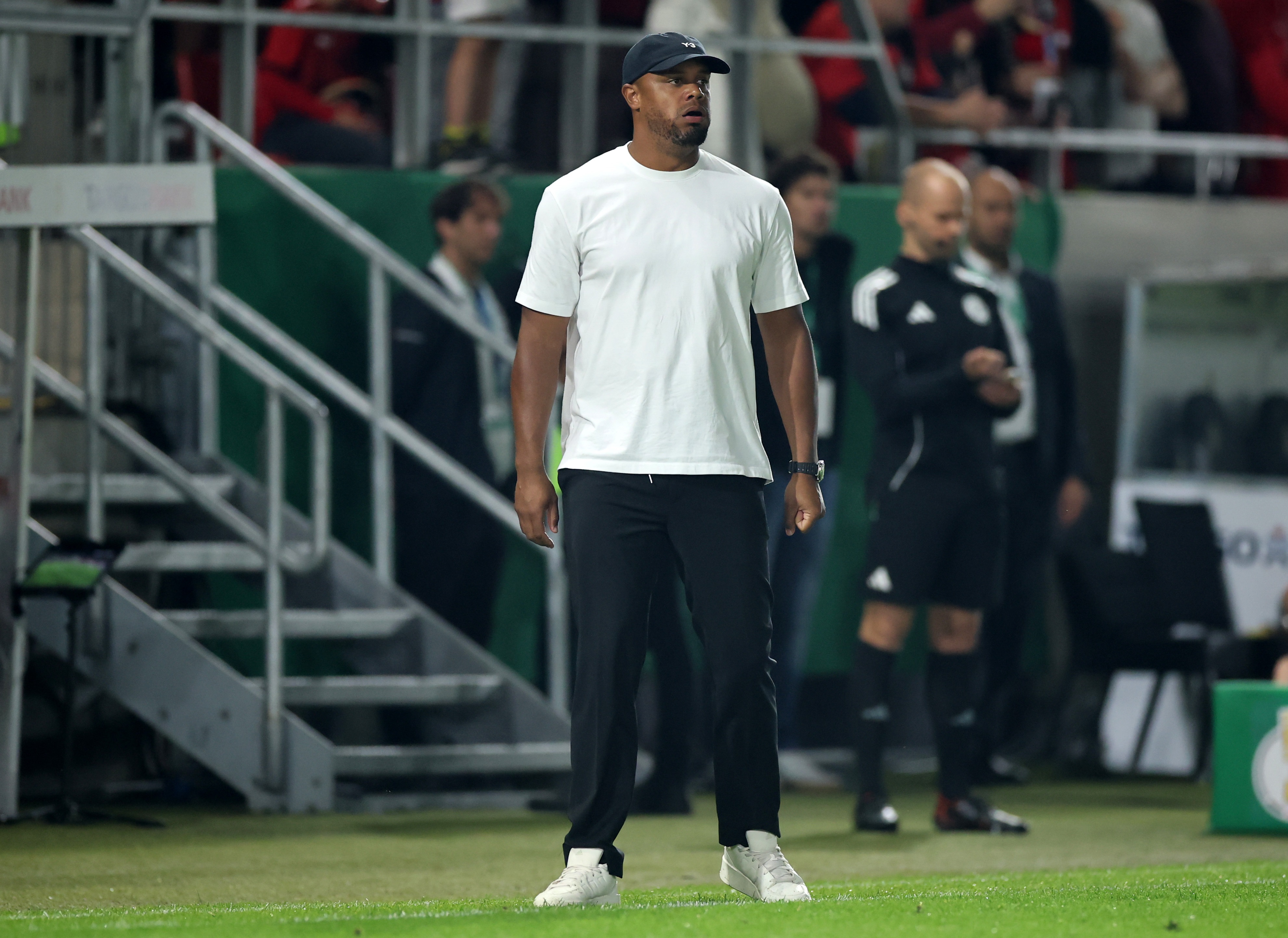 Vincent Kompany stands on the pitch during Bayern game.