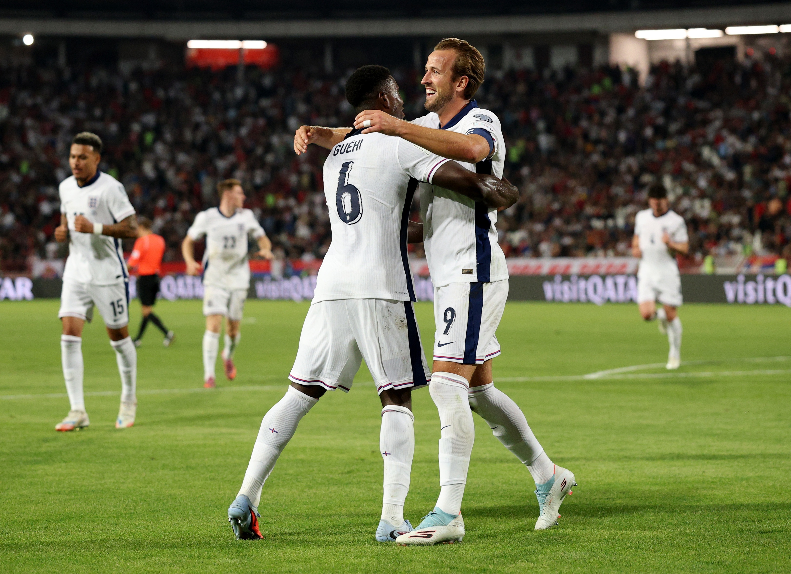 Marc Guehi hugs Harry Kane during England game.