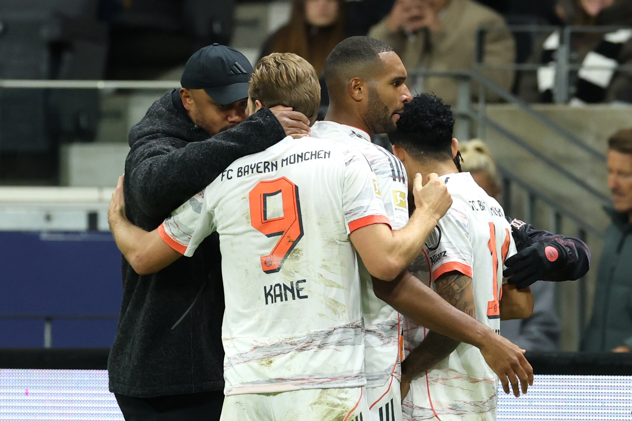 Vincent Kompany embraces Bayern striker Harry Kane on the touchline.