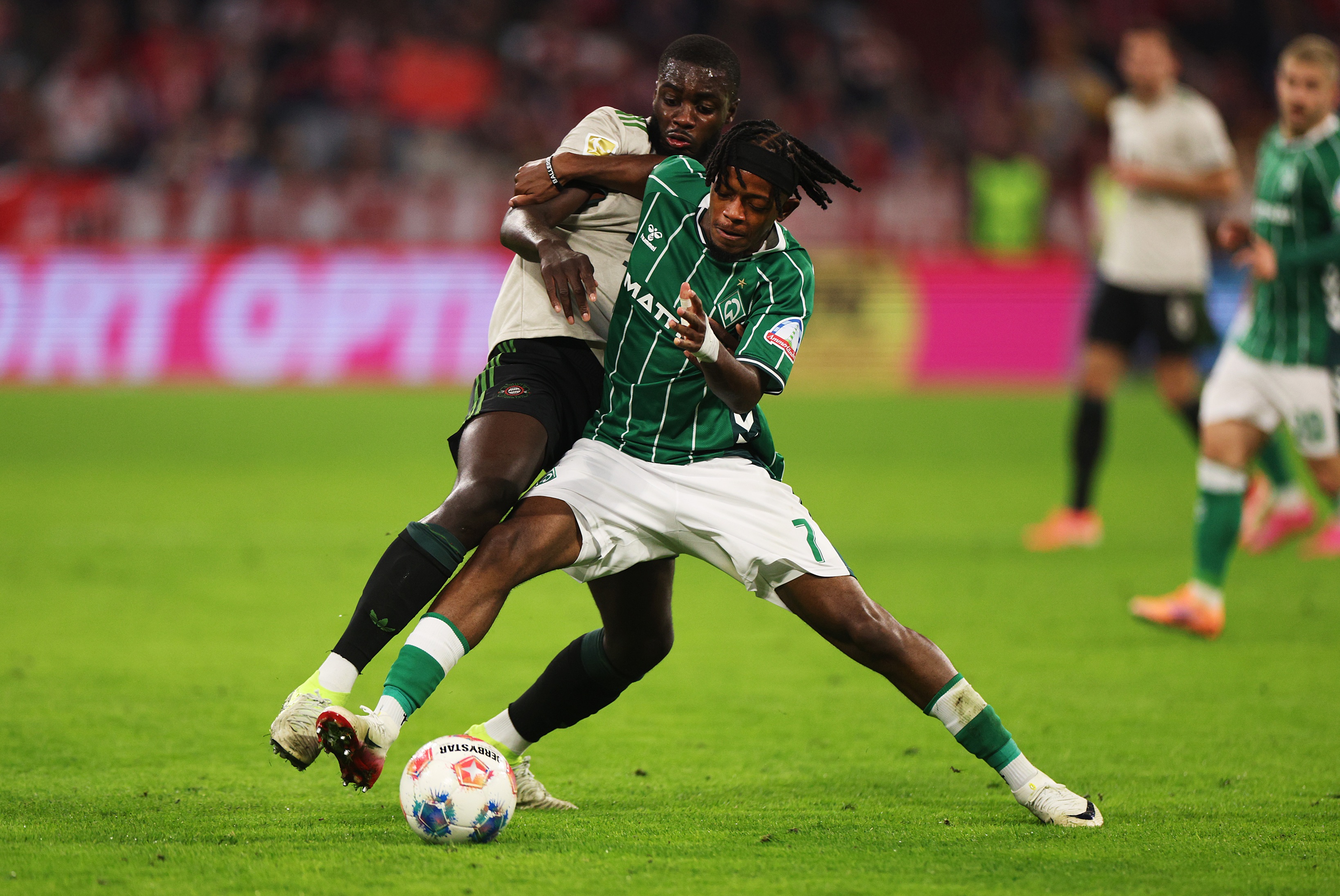 Dayot Upamecano tangles with Werder Bremen star Samuel Mbangula.