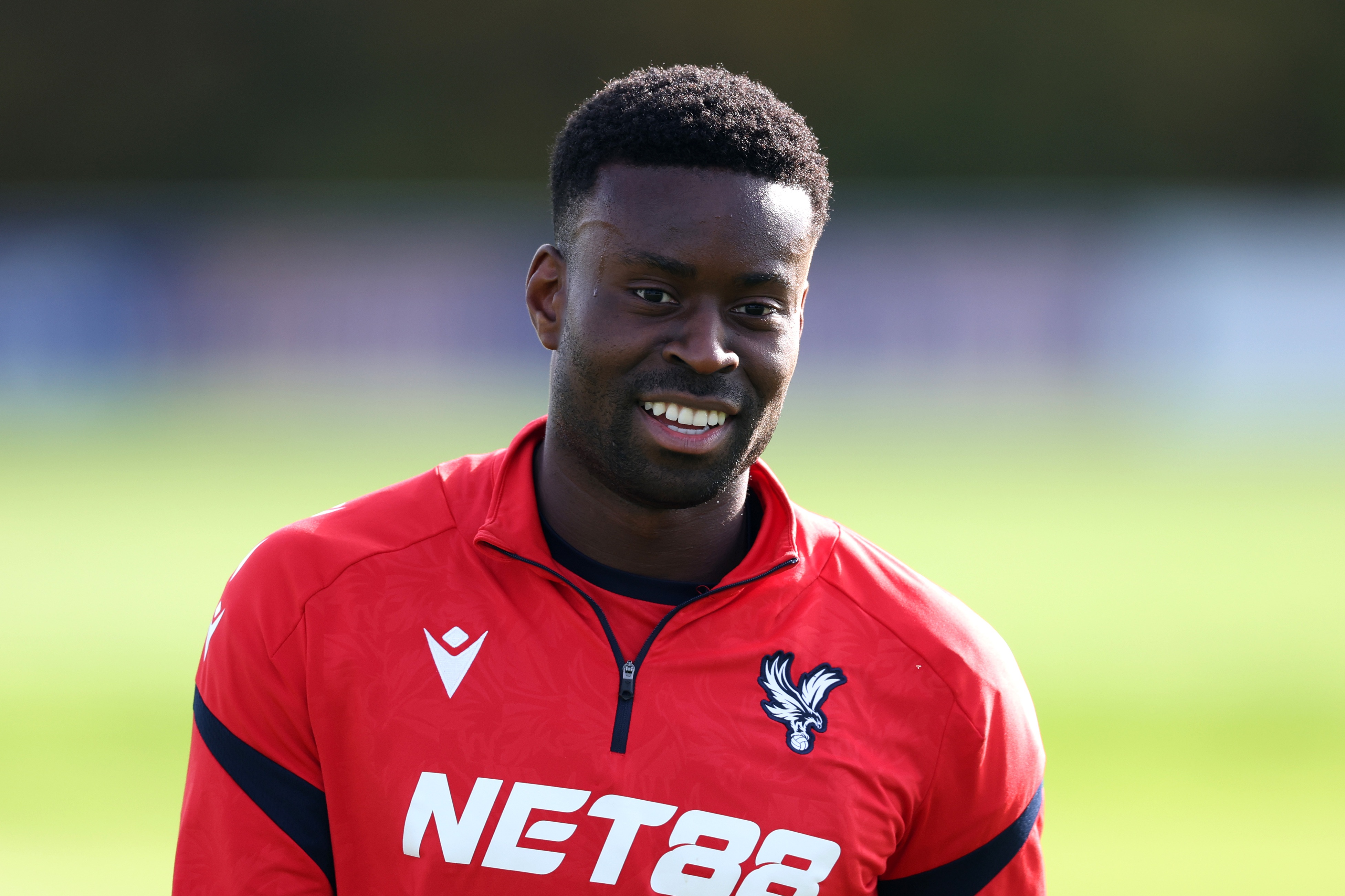 Marc Guehi smiles during Crystal Palace training.