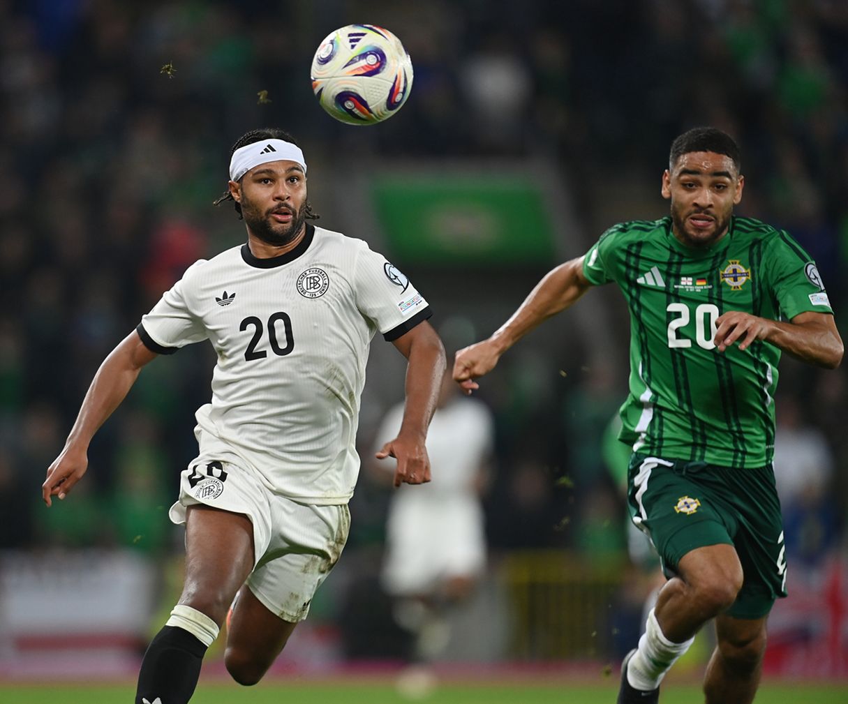 Serge Gnabry and Brodie Spencer chase a loose ball.