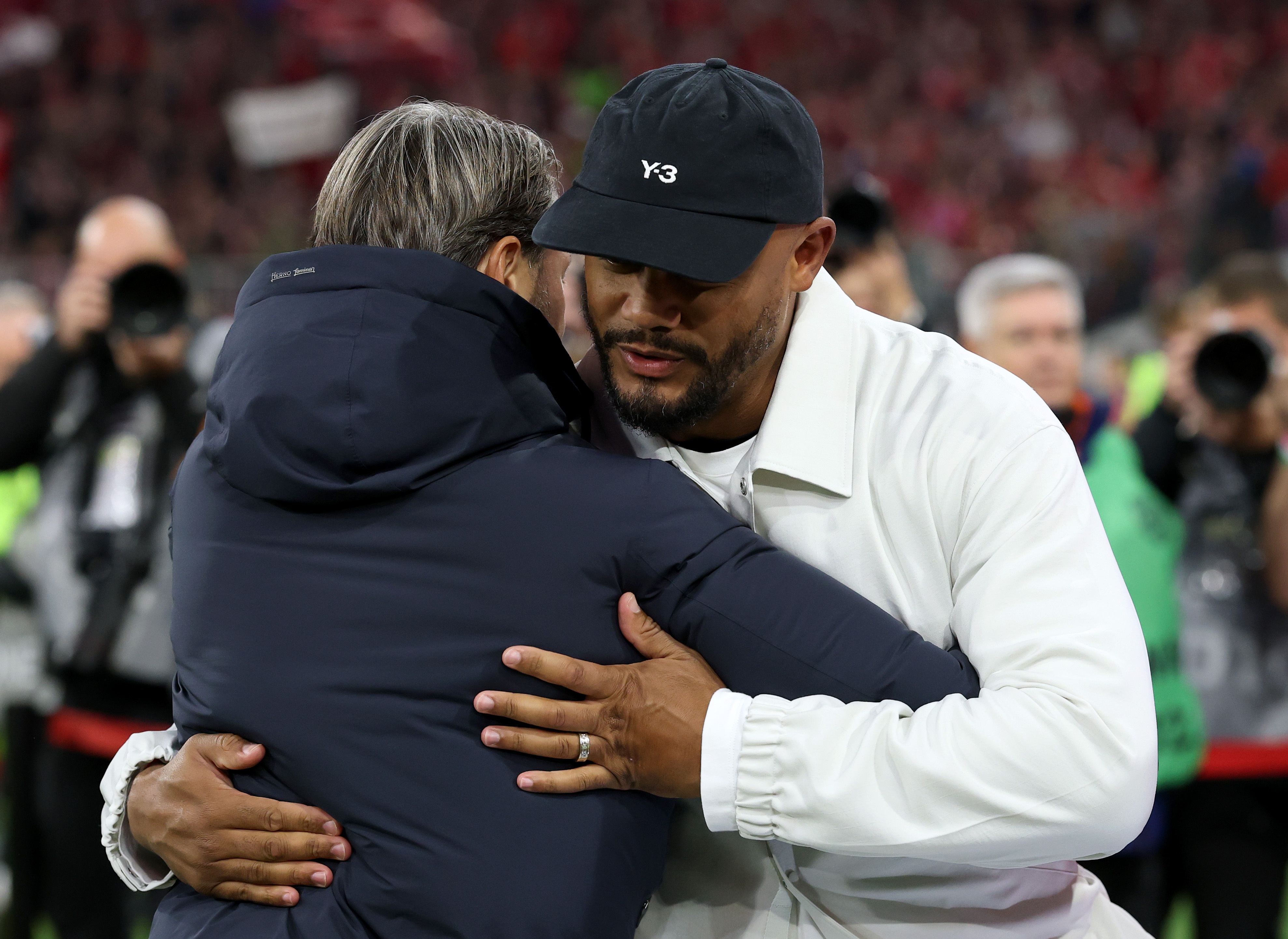 Vincent Kompany, manager of Bayern Munich, hugs Dortmund head coach Niko Kovac.
