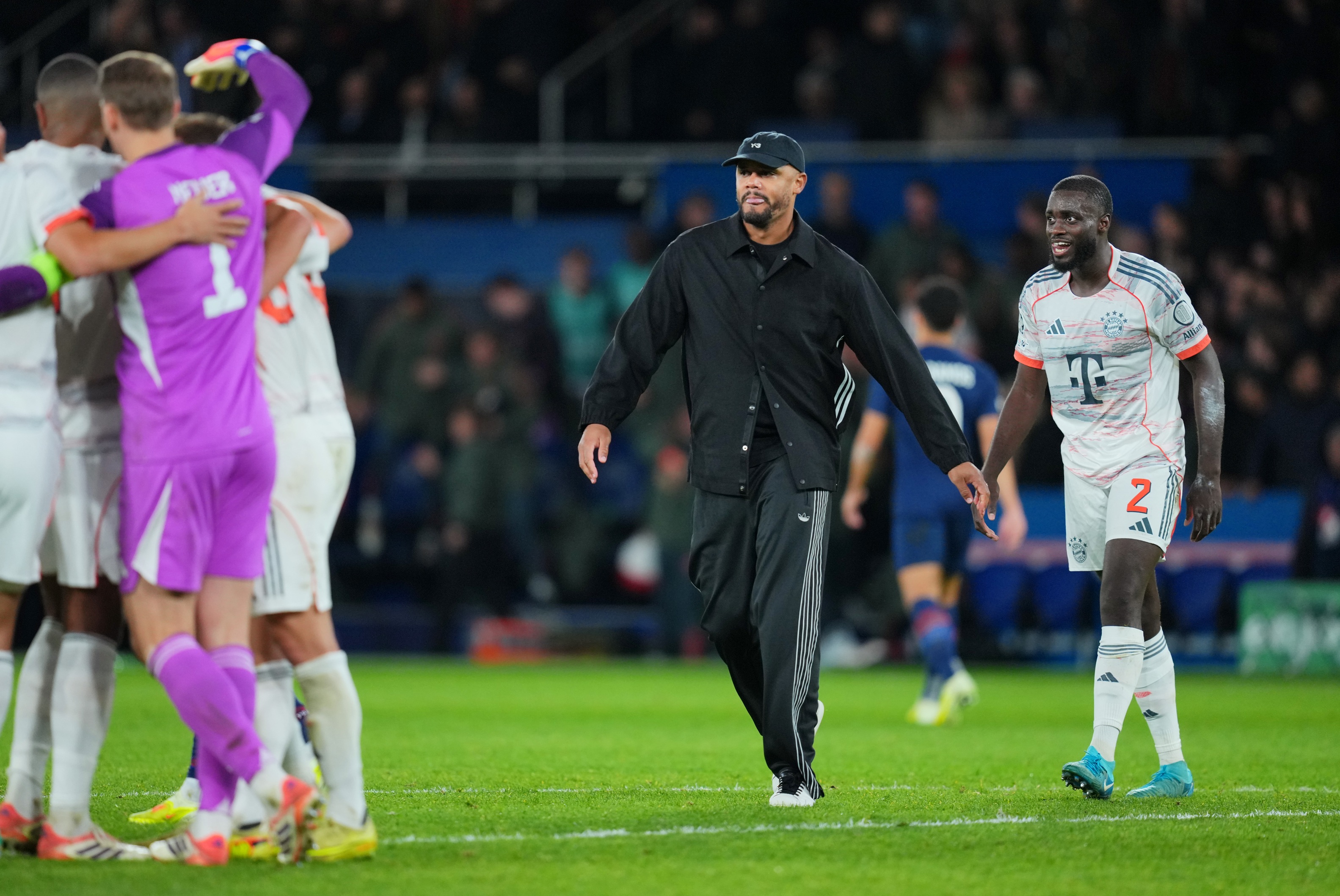 Vincent Kompany walks in front of Dayot Upamecano.