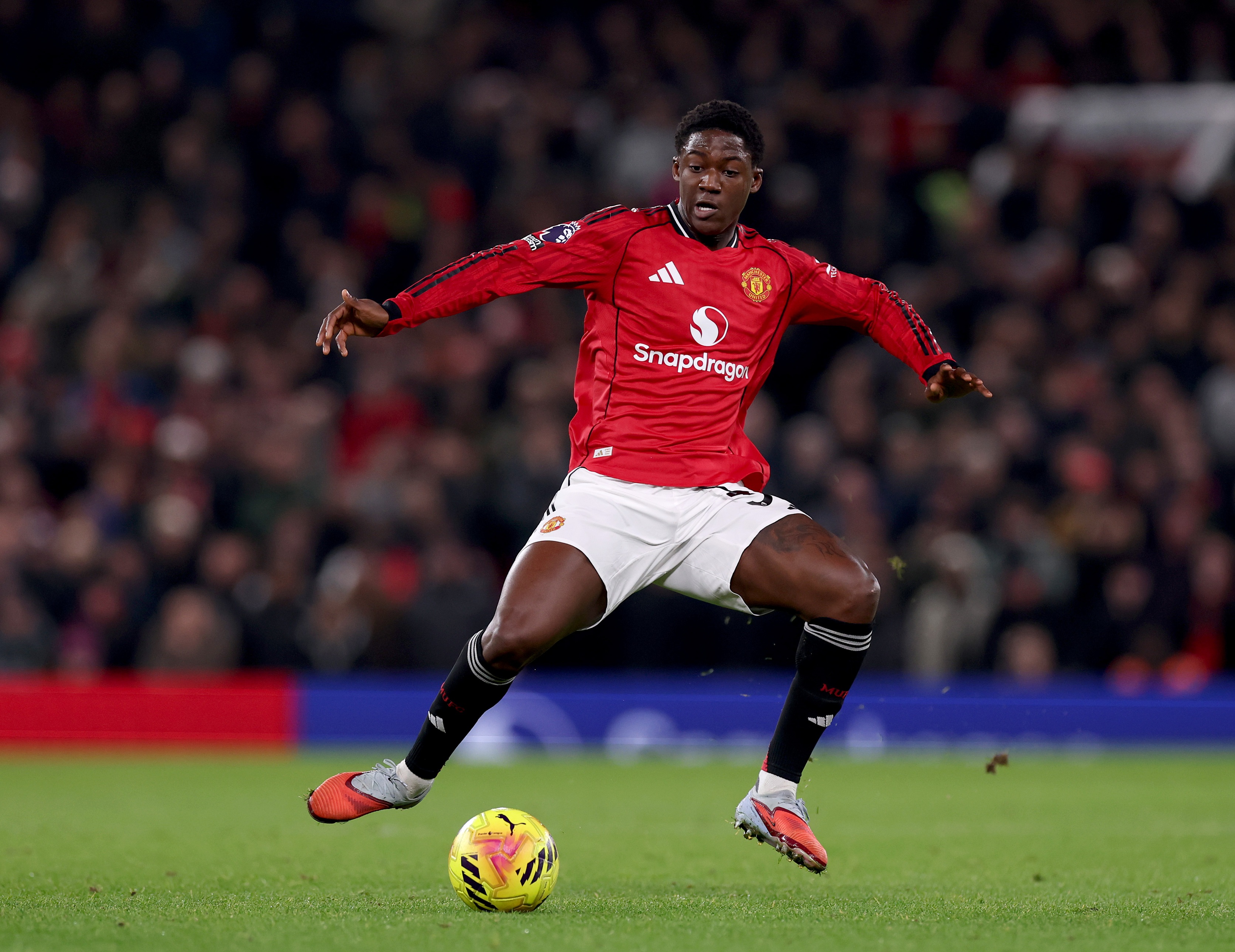 Kobbie Mainoo controls a football.