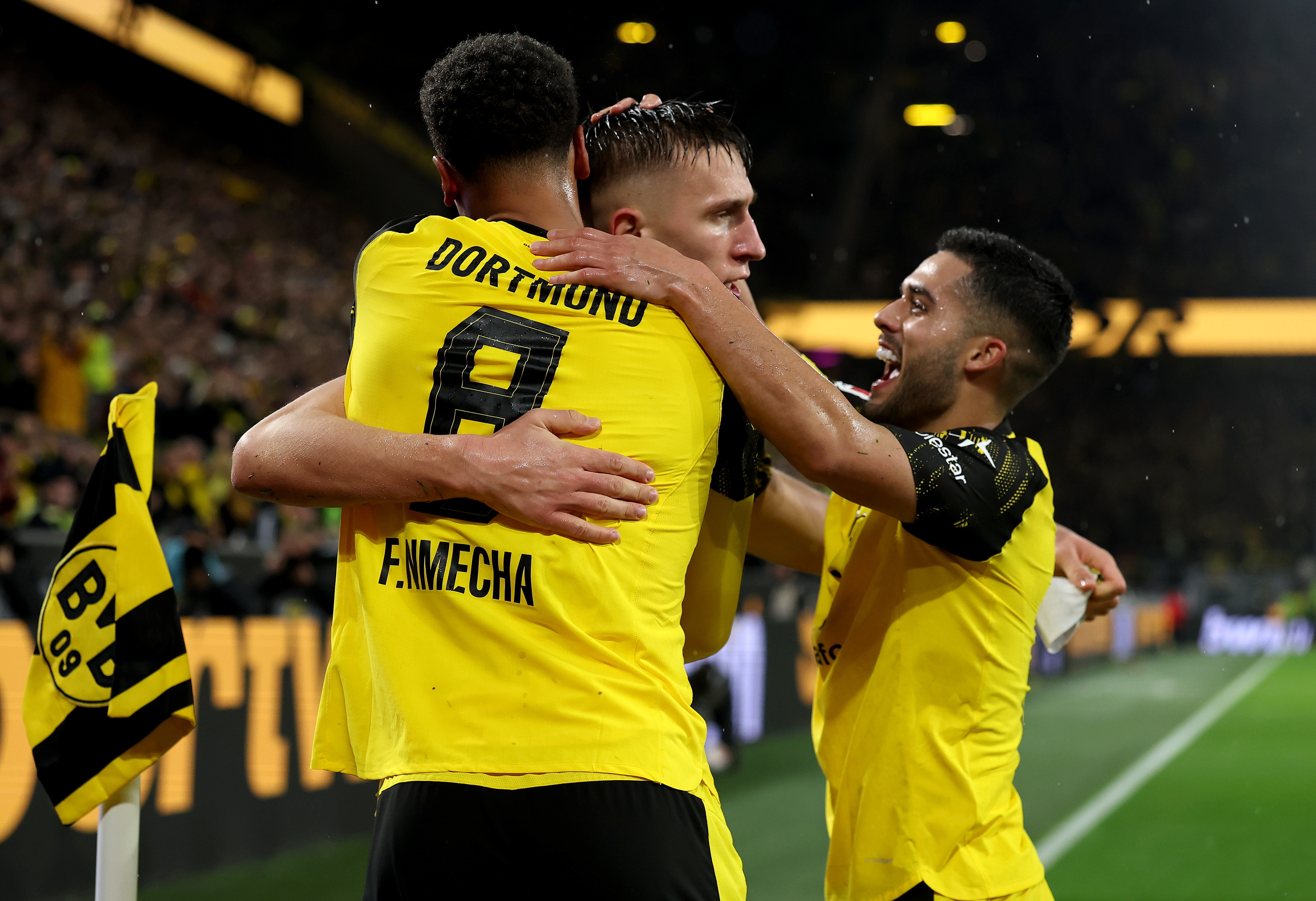 Nico Schlotterbeck hugs Dortmund teammates.