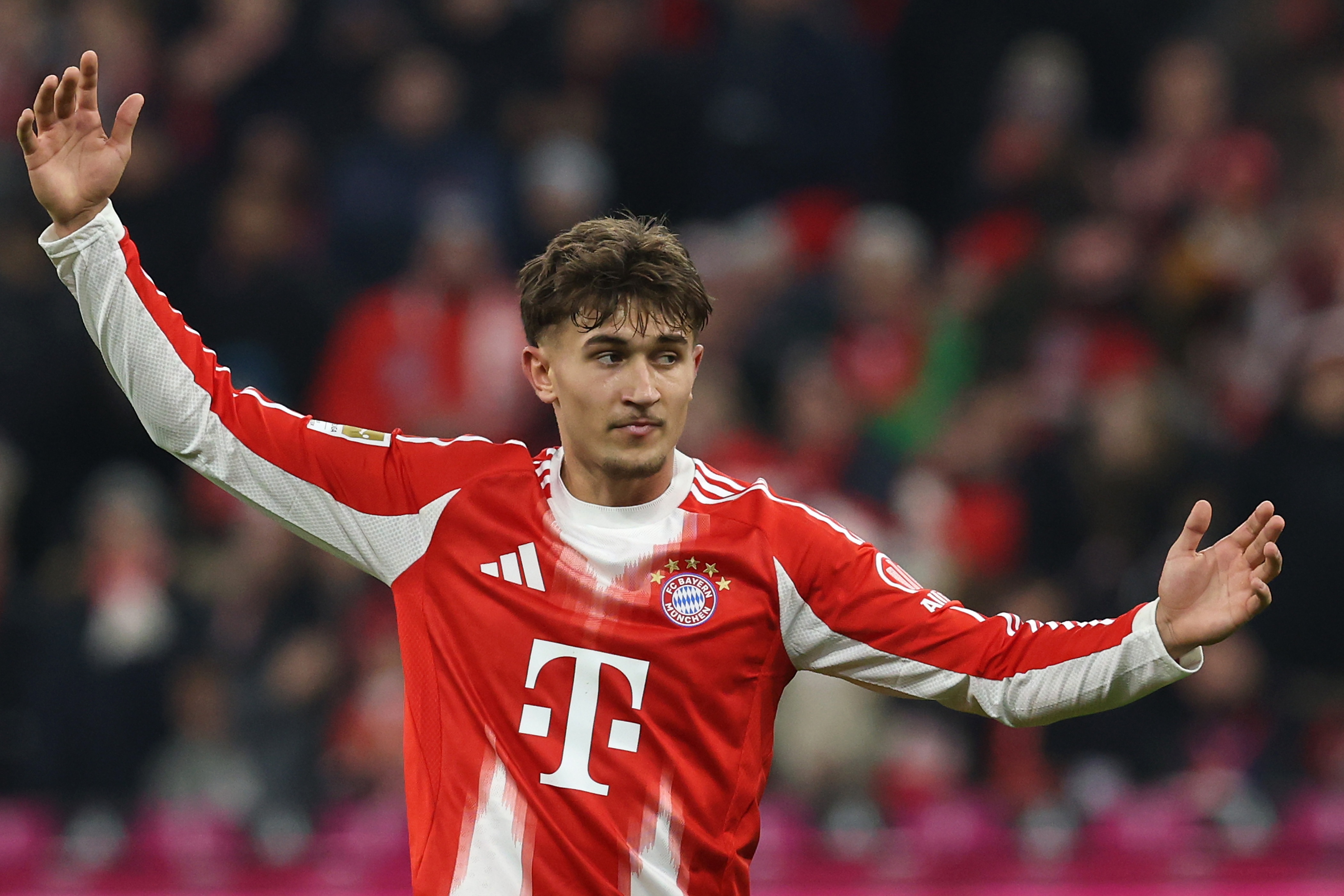 Tom Bischof holds his arms out wide.