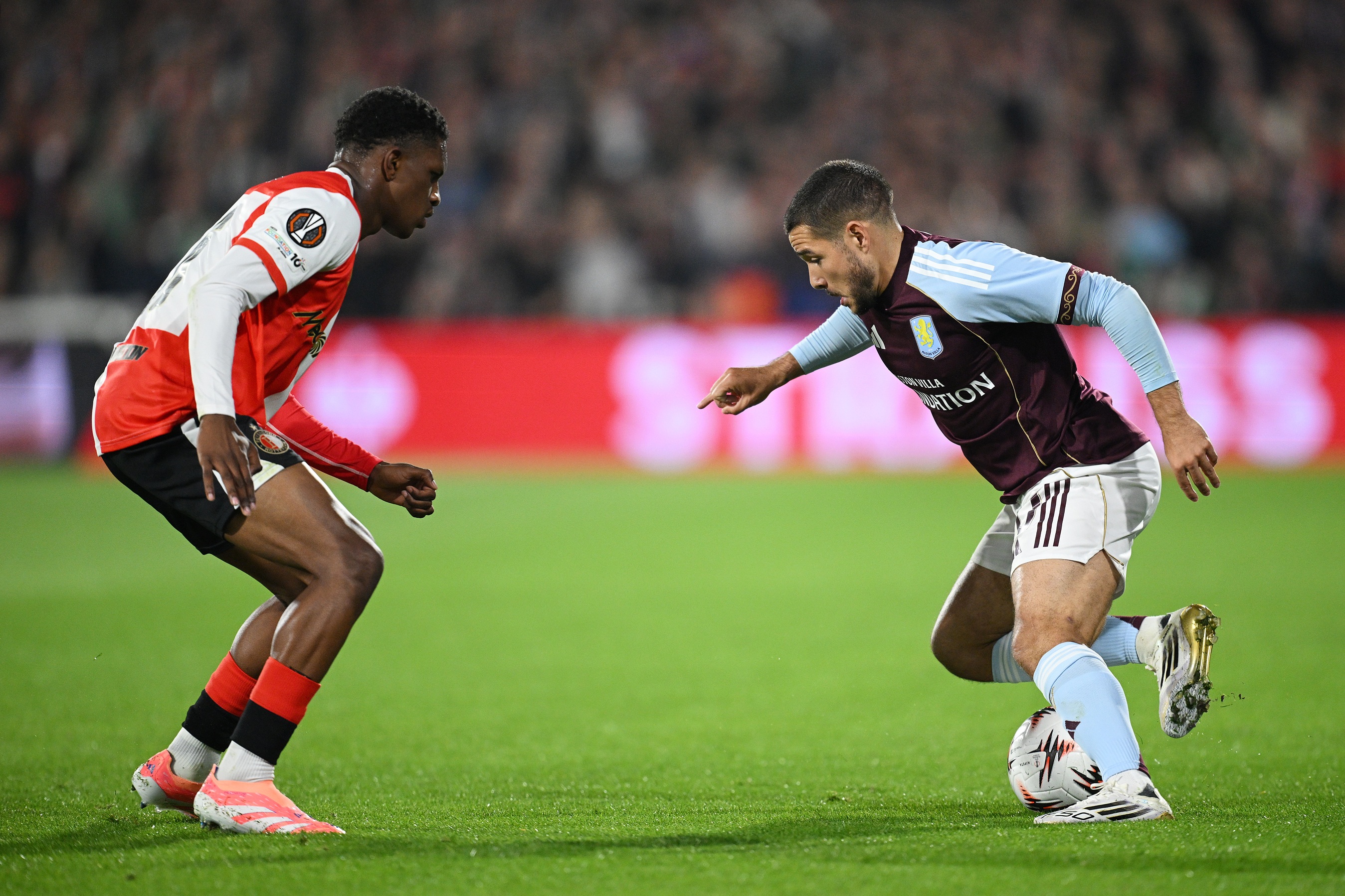 Givairo Read crouches in front of Emiliano Buendia.