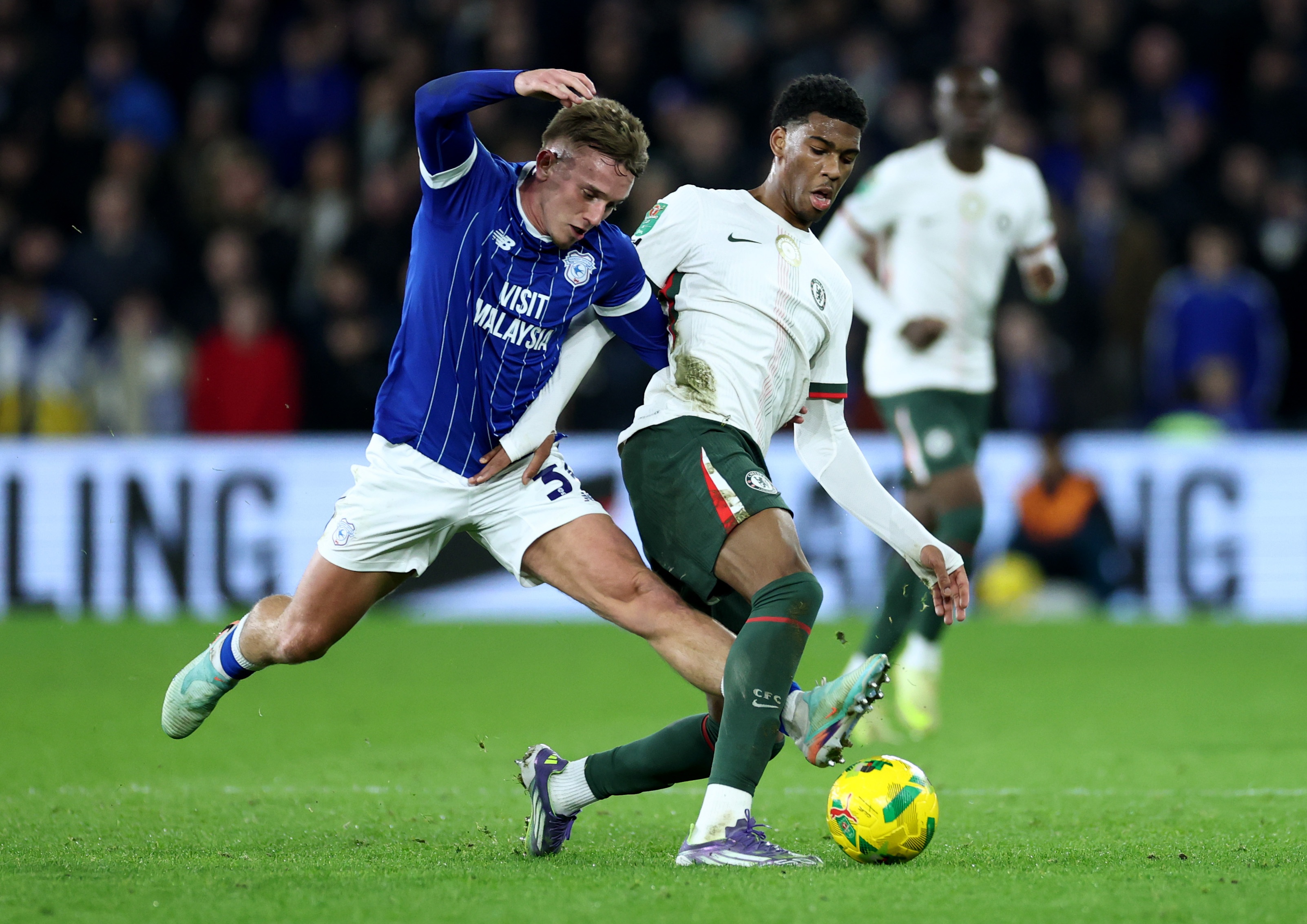 Josh Acheampong holds off Isaak Davies.