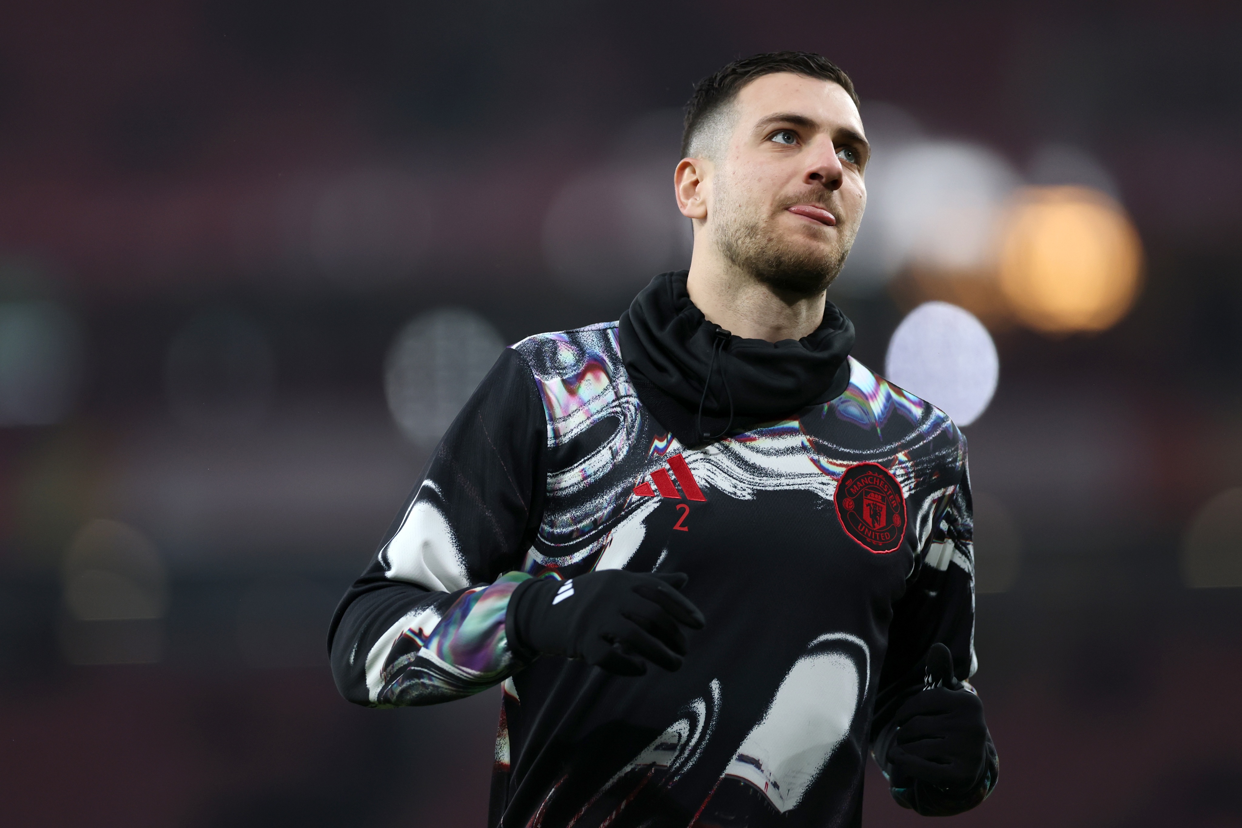 Diogo Dalot runs on the pitch ahead of Manchester United game.