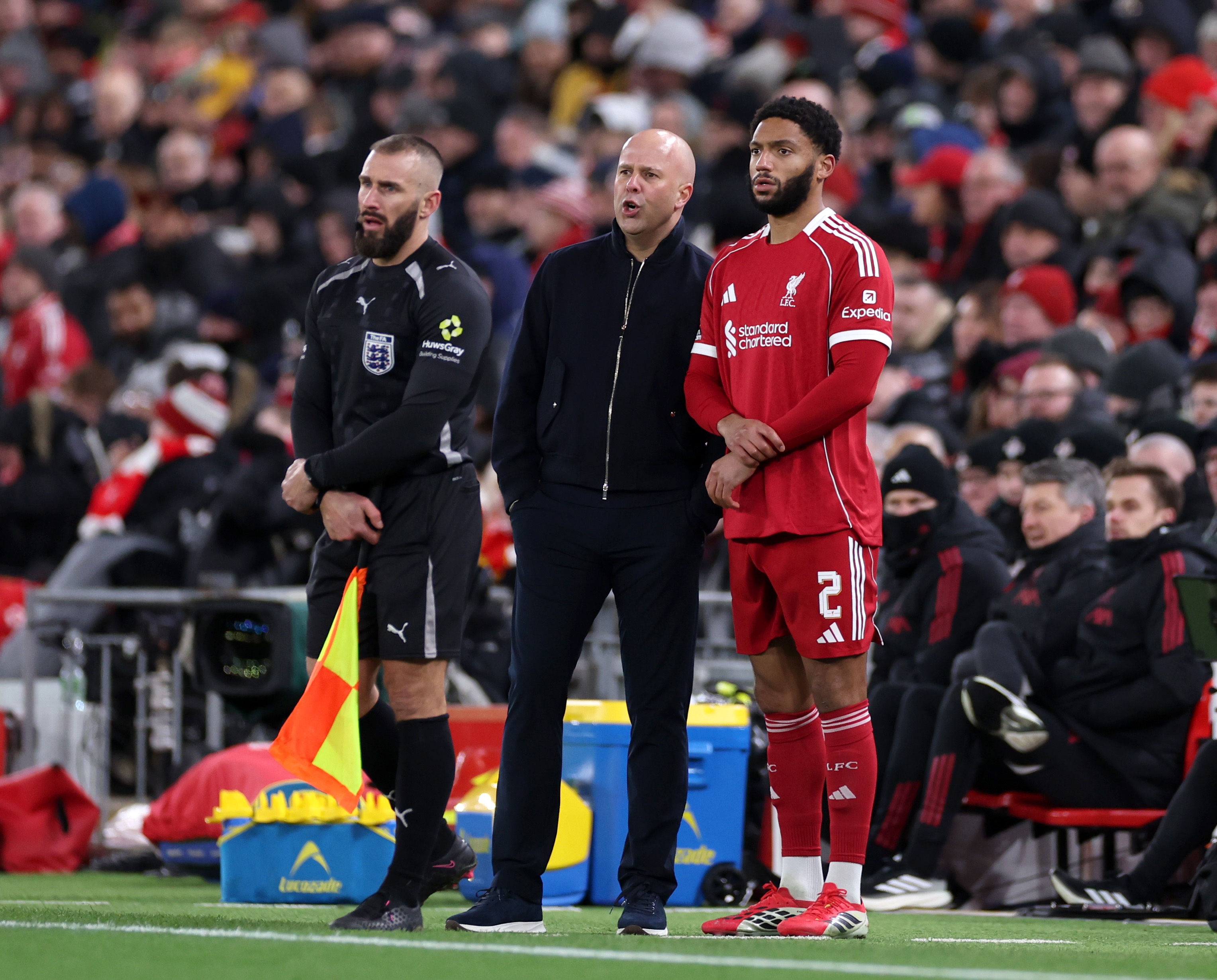 Joe Gomez stands next to Arne Slot during Liverpool game.