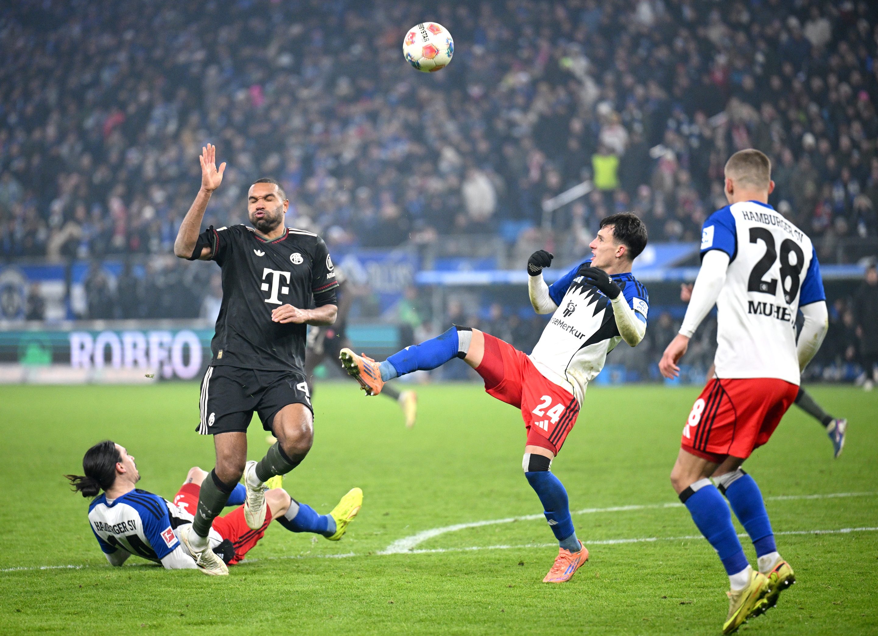 Jonathan Tah battles during Bayern Munich game.
