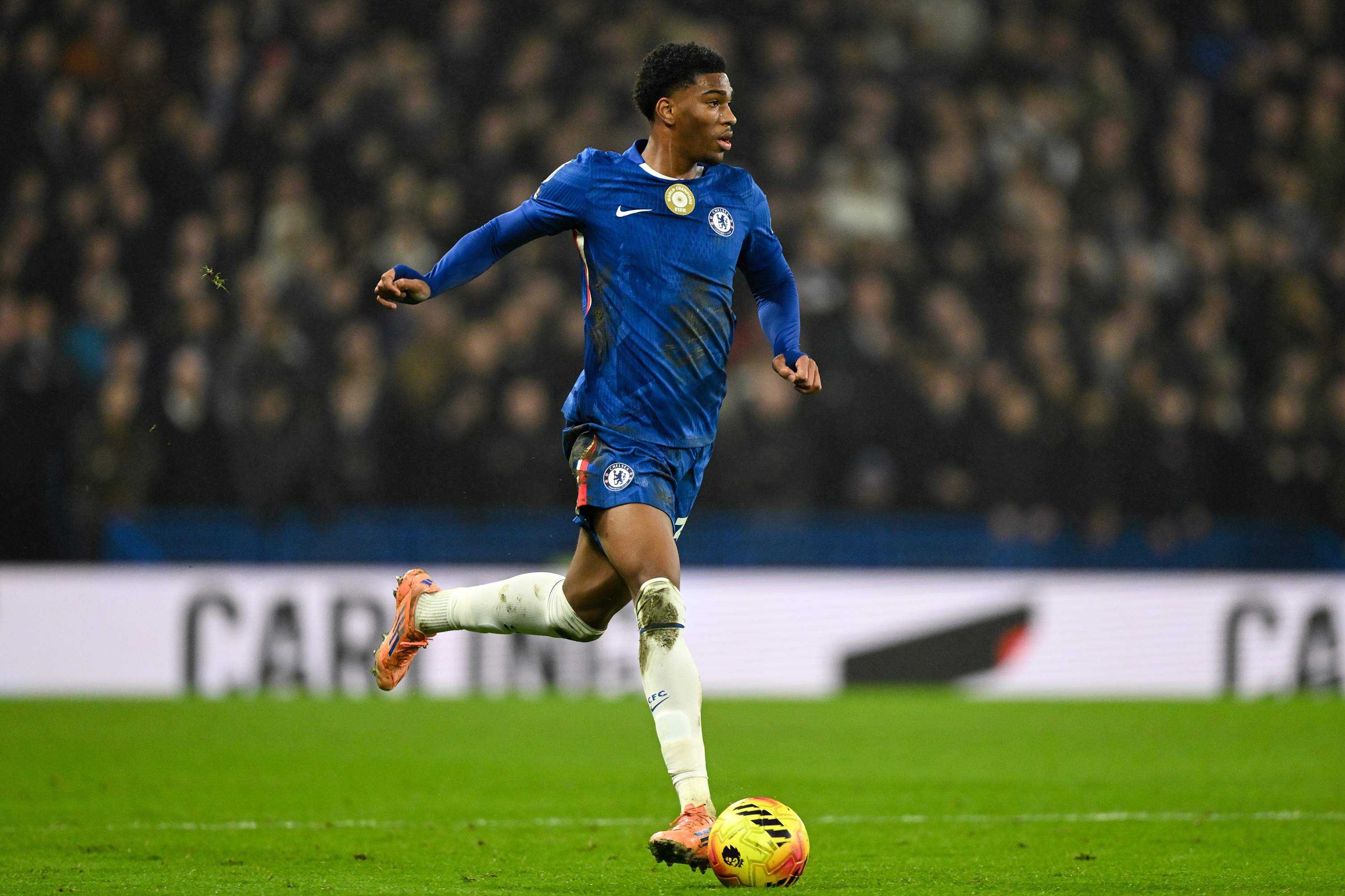 Josh Acheampong dribbles with the ball during Chelsea match.