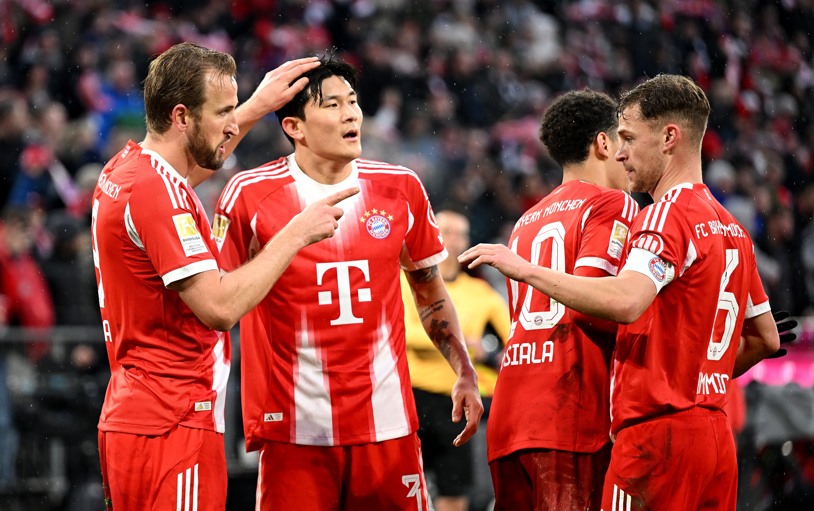 Kim Min-jae celebrates with Bayern Munich teammates.