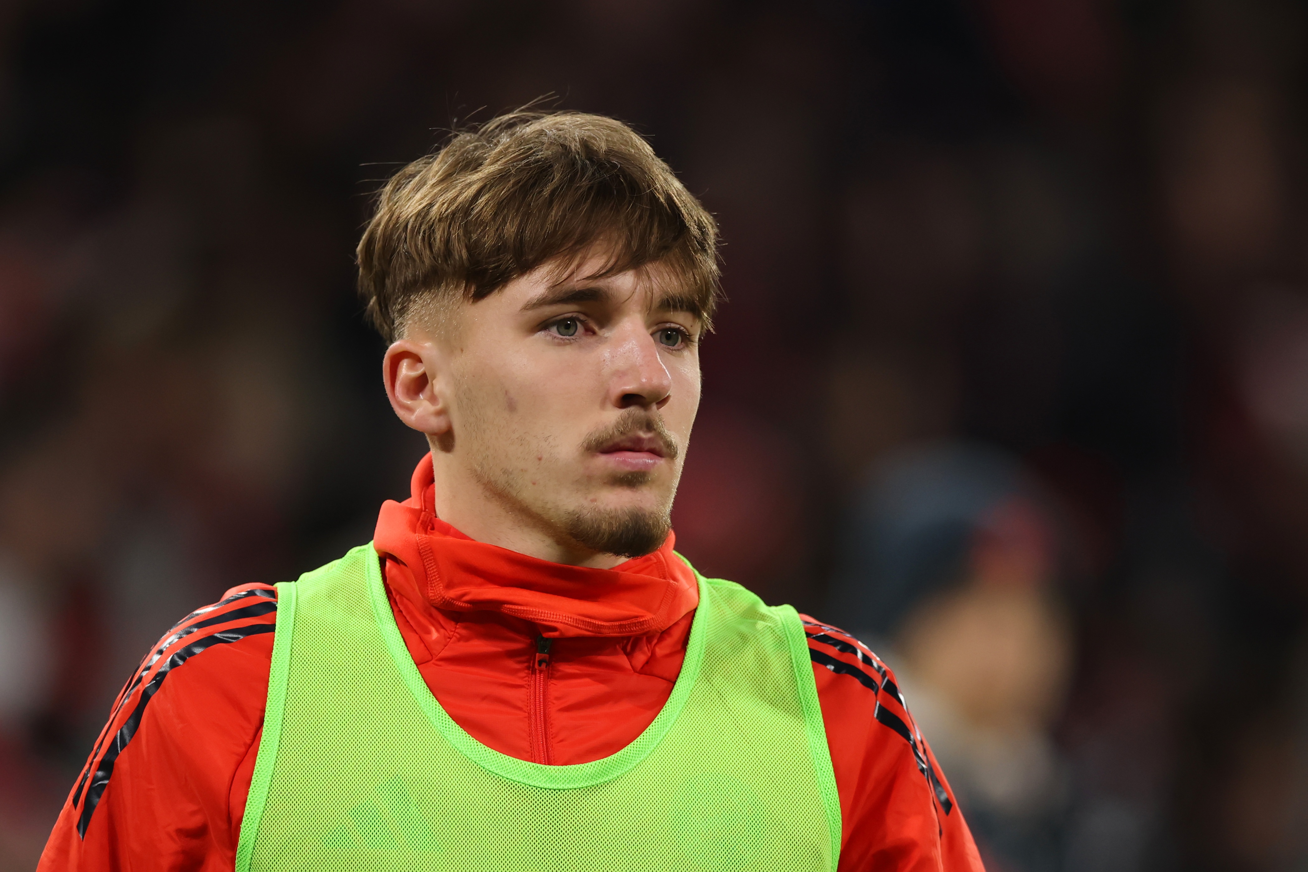 Lennart Karl wears a subs bib and looks on during Bayern game.