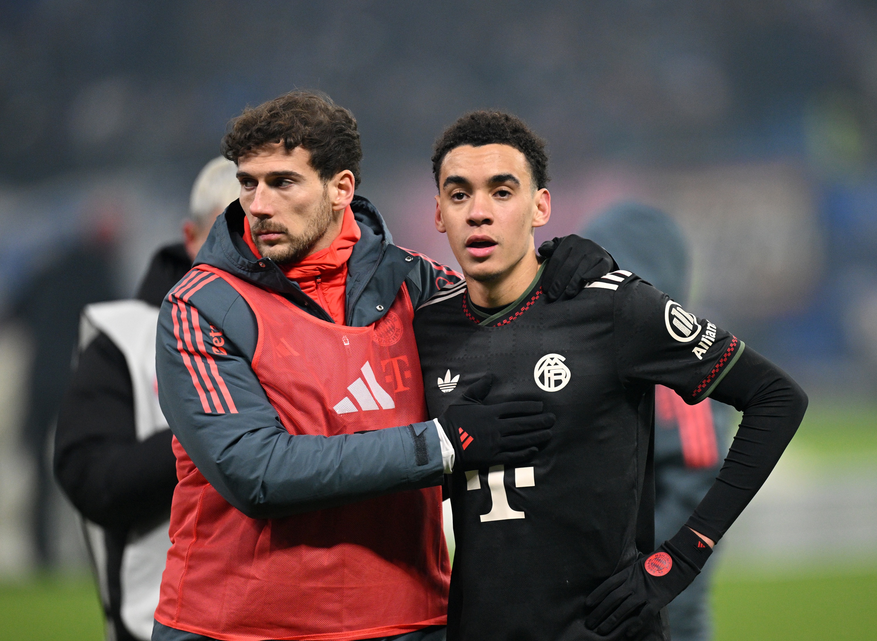 Leon Goretzka puts his arm around Jamal Musiala during Bayern game.