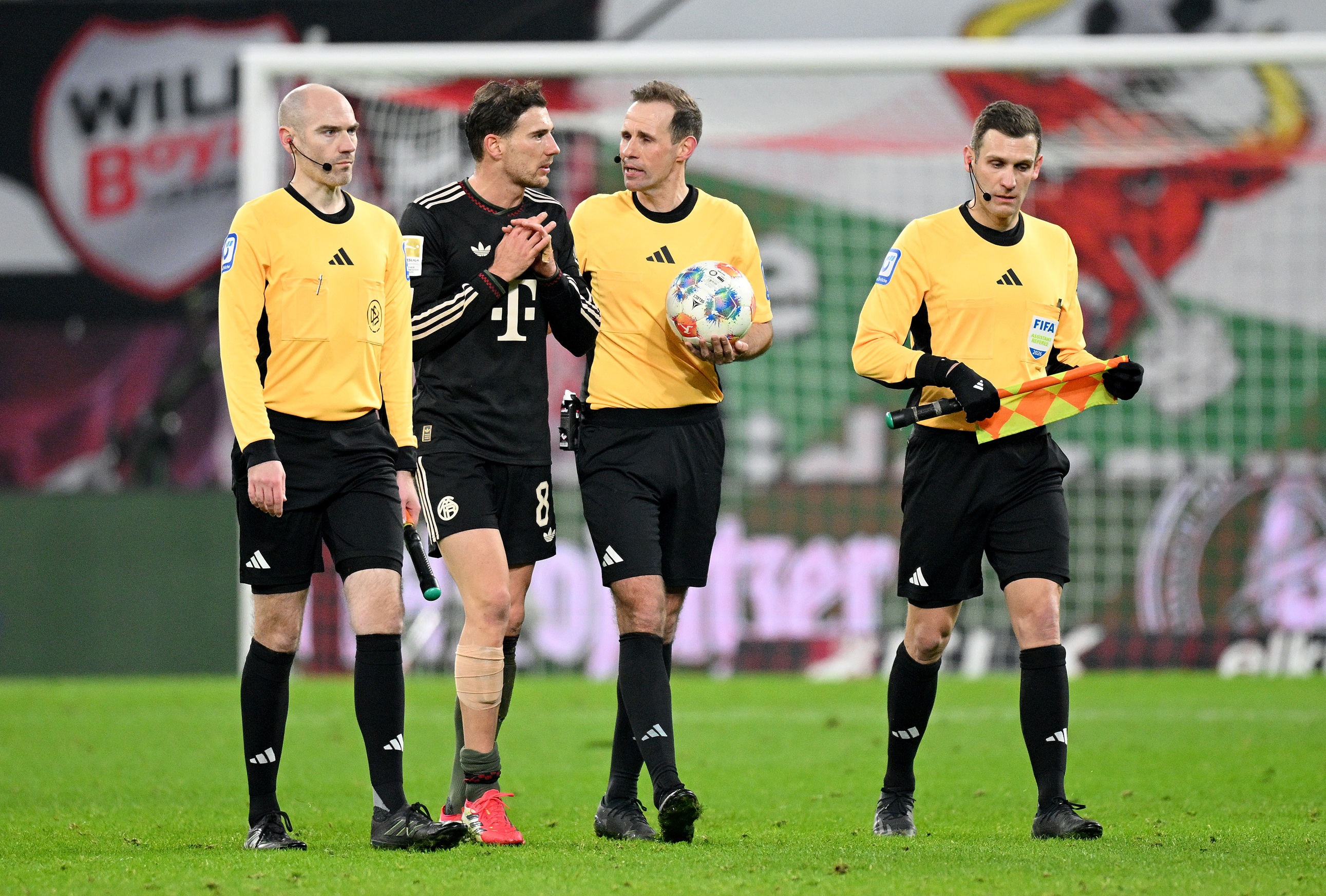 Leon Goretzka speaks with referee during Bayern game.