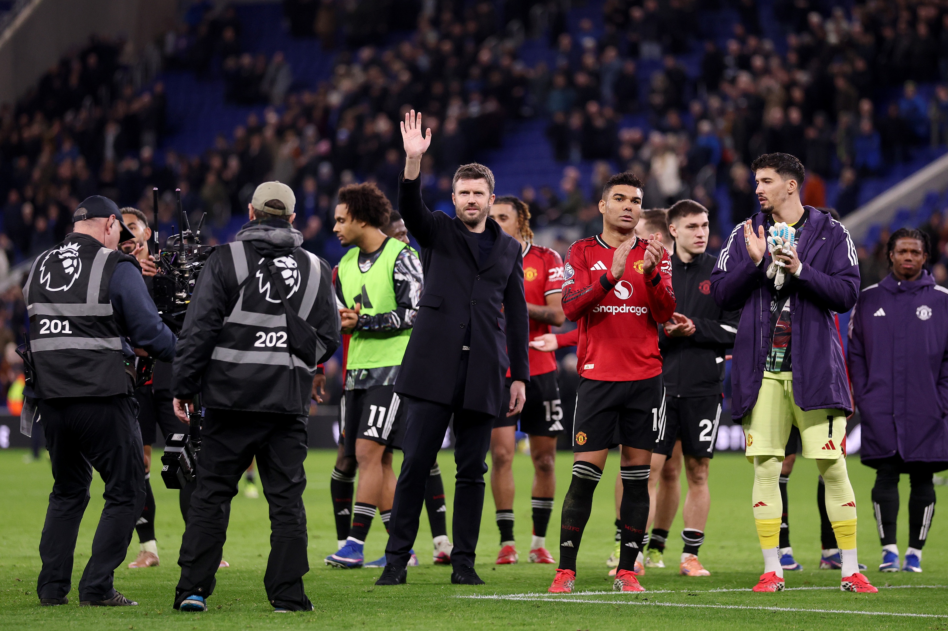 Michael Carrick waves at the camera.
