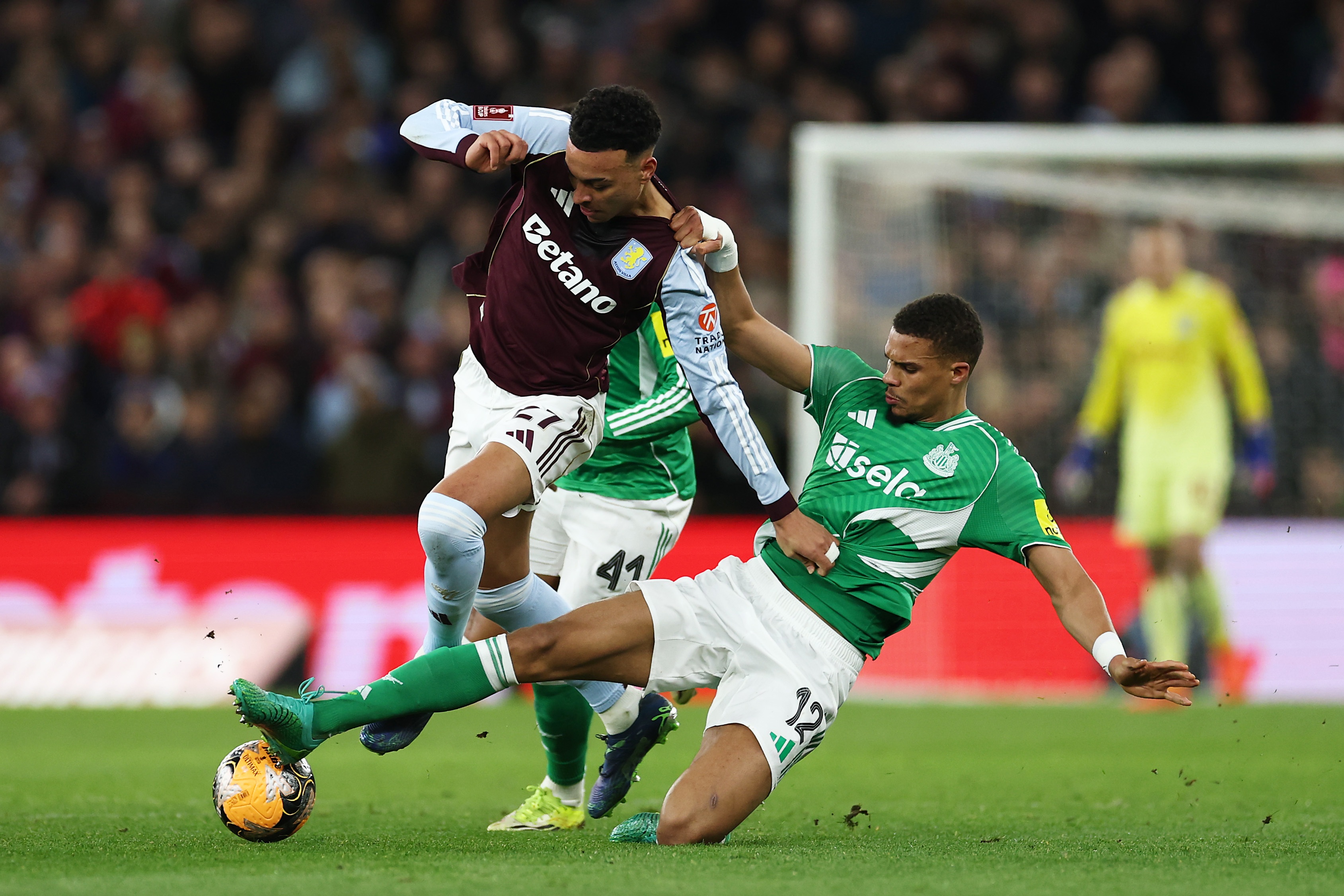 Malick Thiaw tackles Morgan Rogers during Newcastle game.