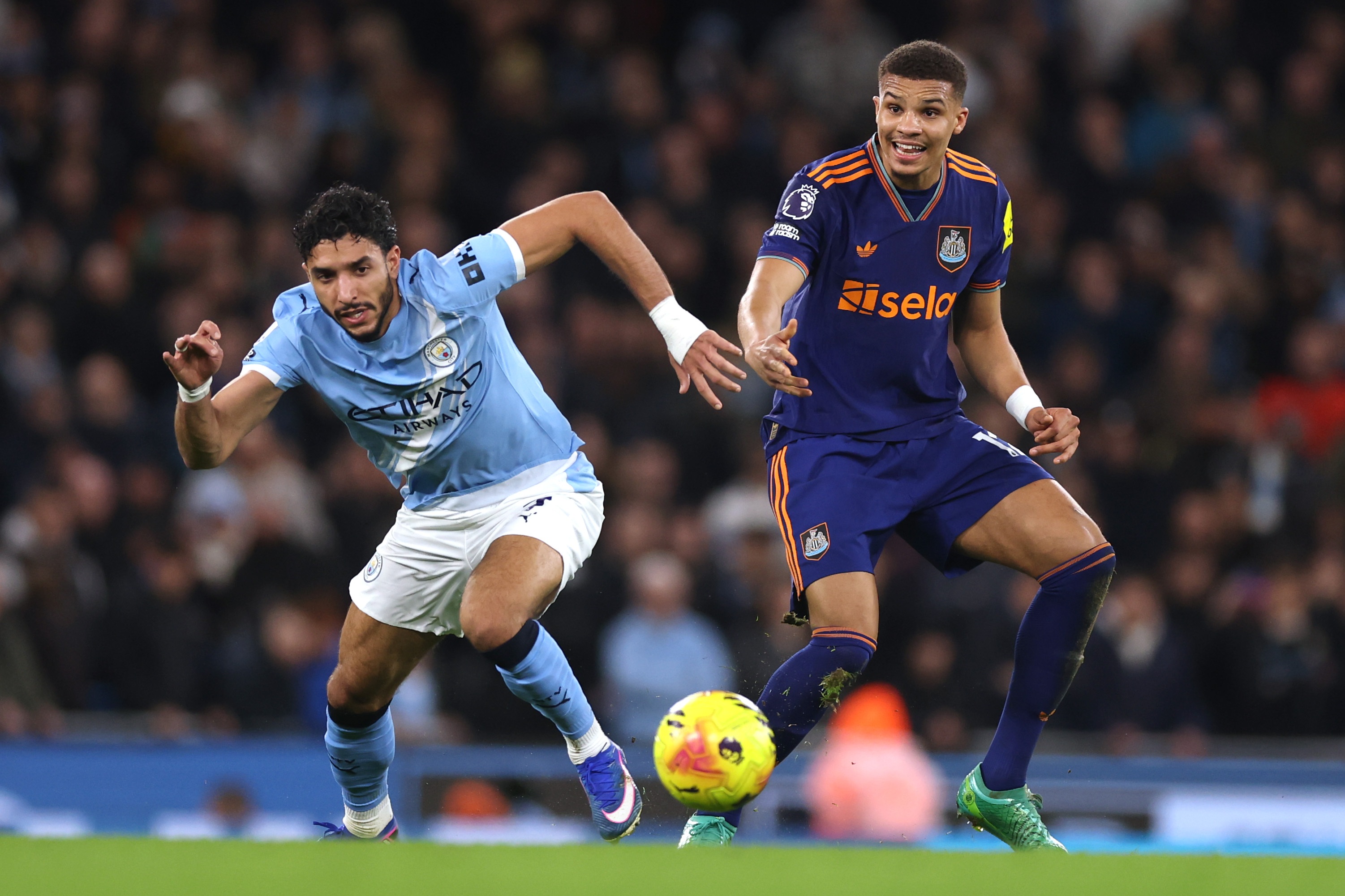 Malick Thiaw competes with Manchester City's Omar Marmoush for the ball.