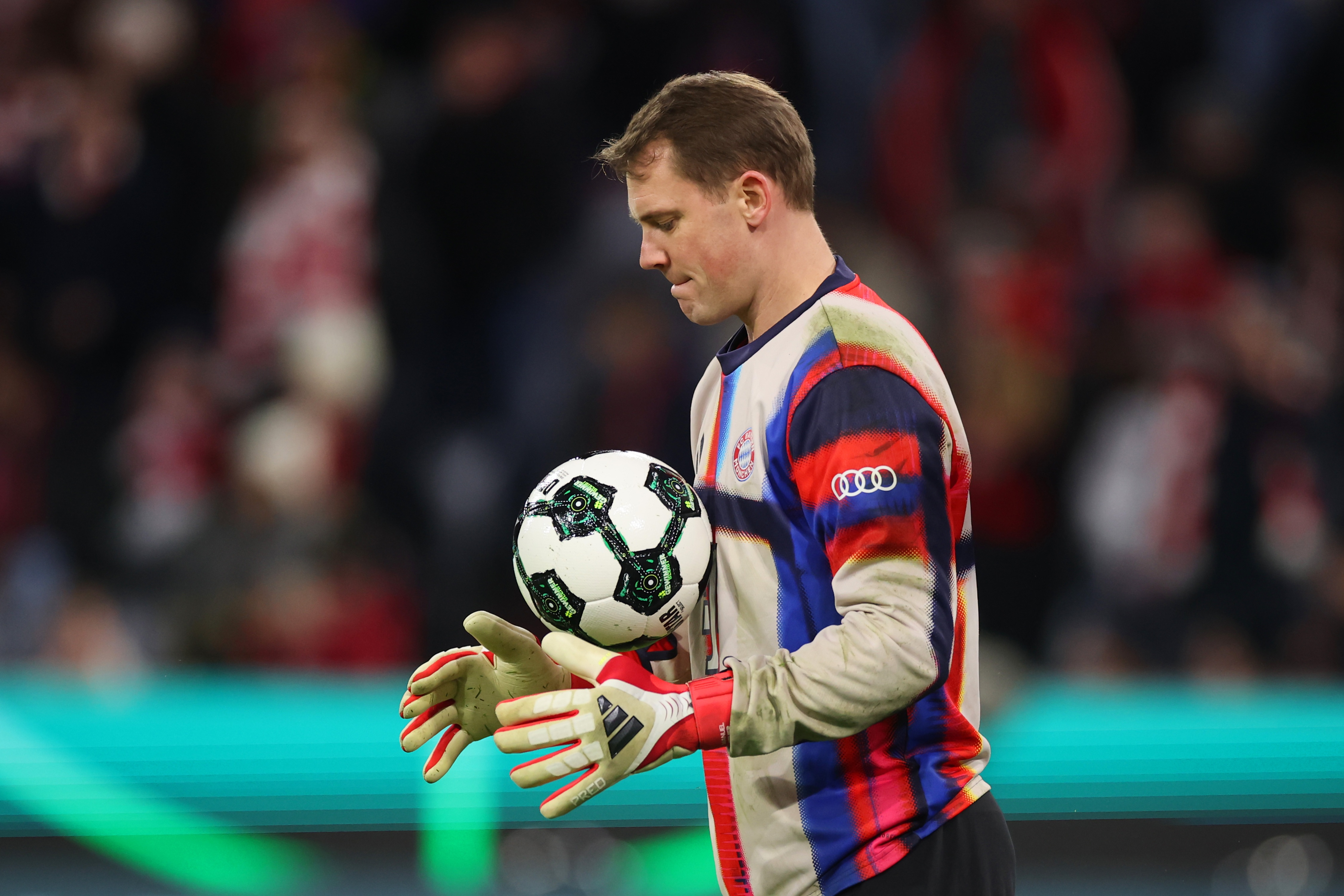 Manuel Neuer throws a ball up in the air.