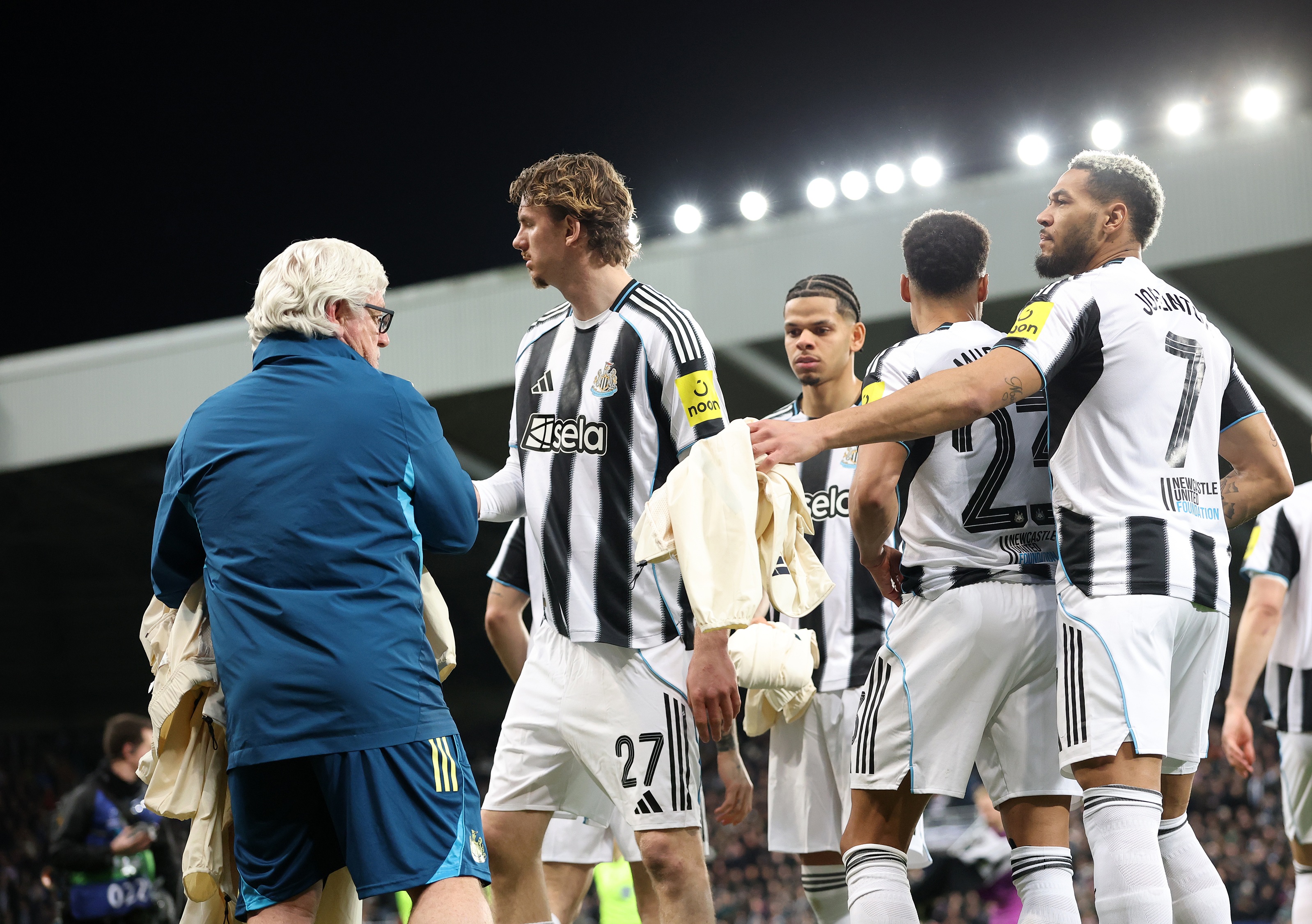 Nick Woltemade hands over jacket to Newcastle kit man.