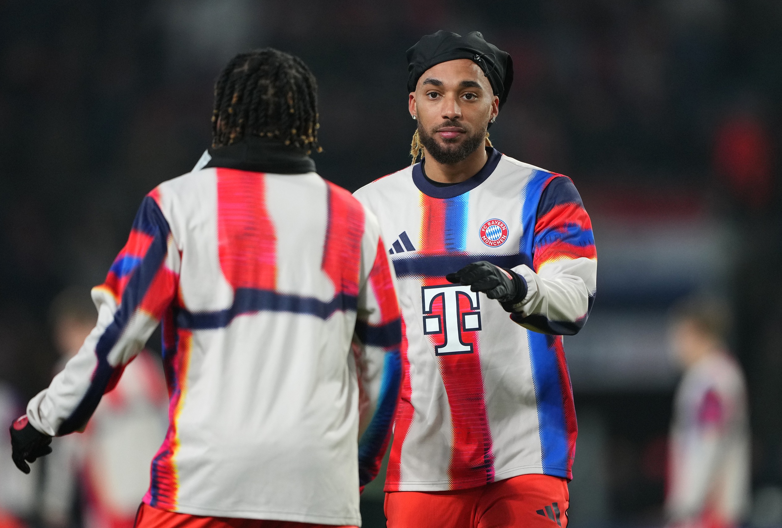 Sacha Boey interacts with Bayern Munich teammate.