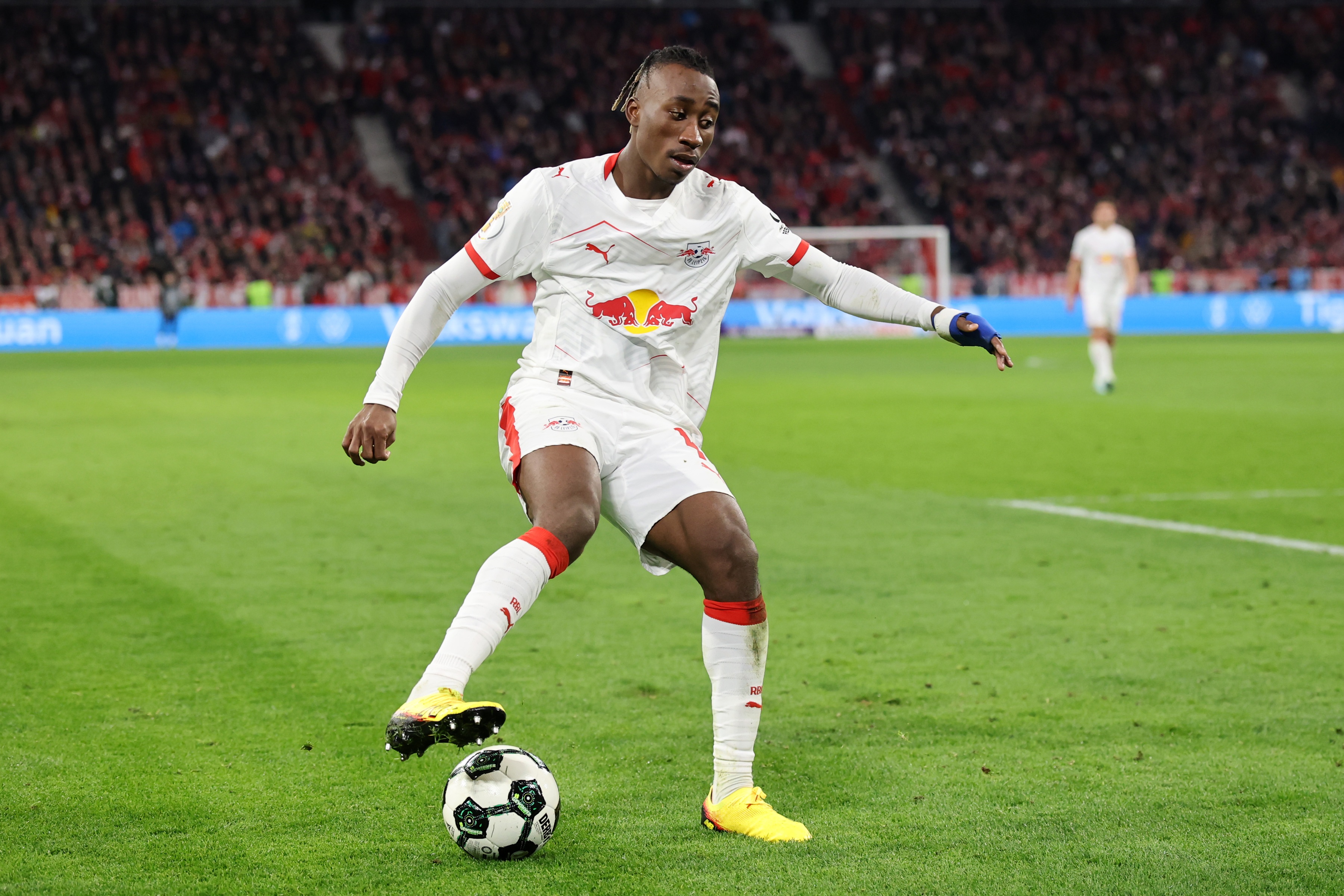 Yan Diomande puts his boot on the ball during RB Leipzig game.