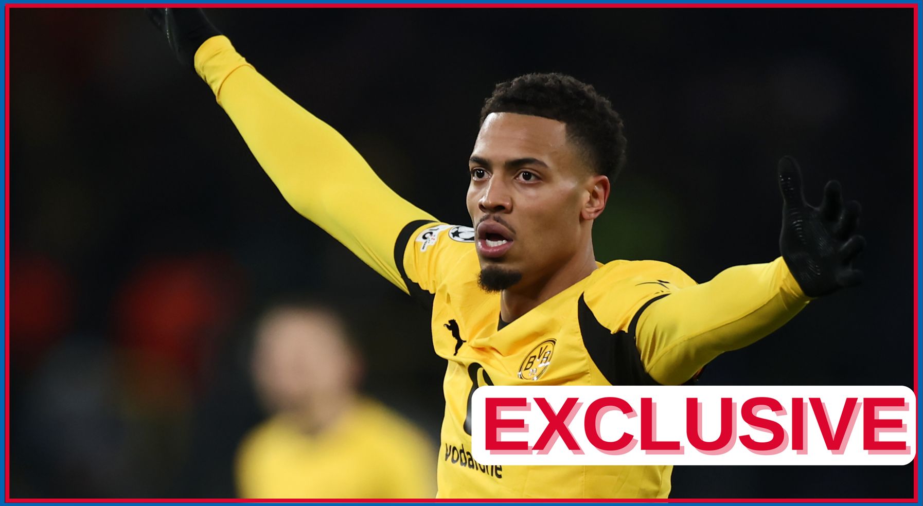 Felix Nmecha holds his arms out wide during Dortmund game.