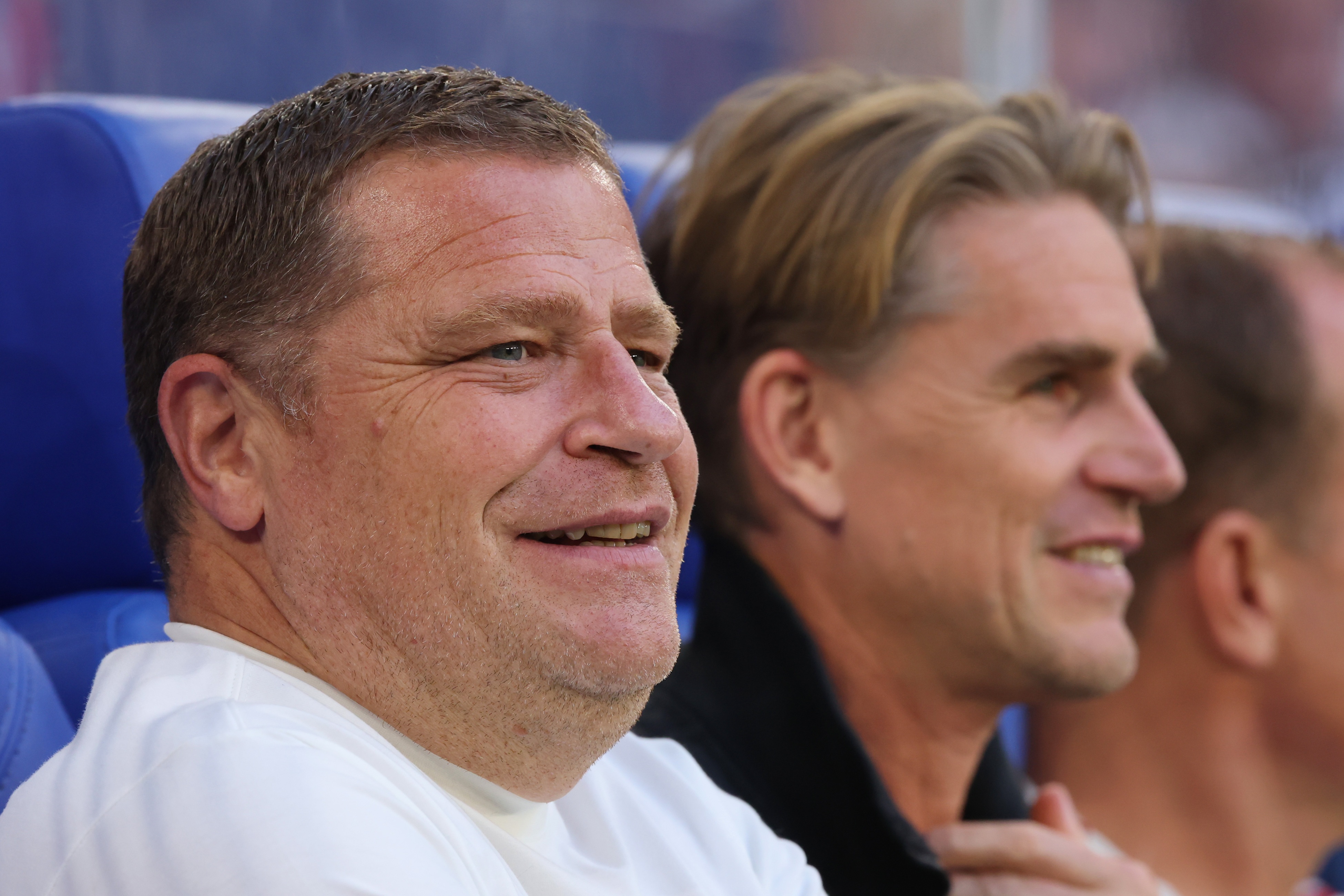 Max Eberl sits next to Christoph Freund during Bayern game.