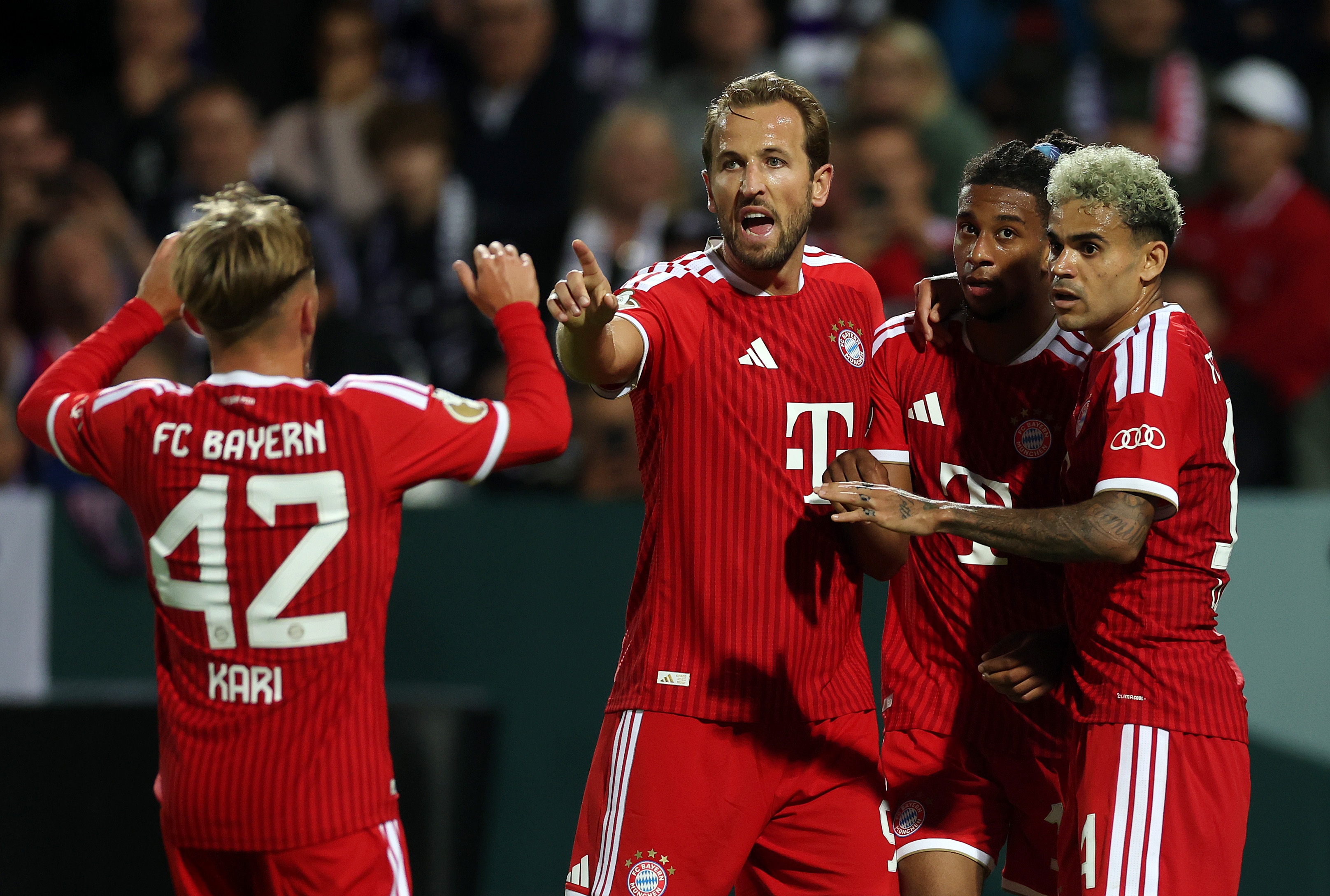 Harry Kane celebrates with Bayern Munich teammates.