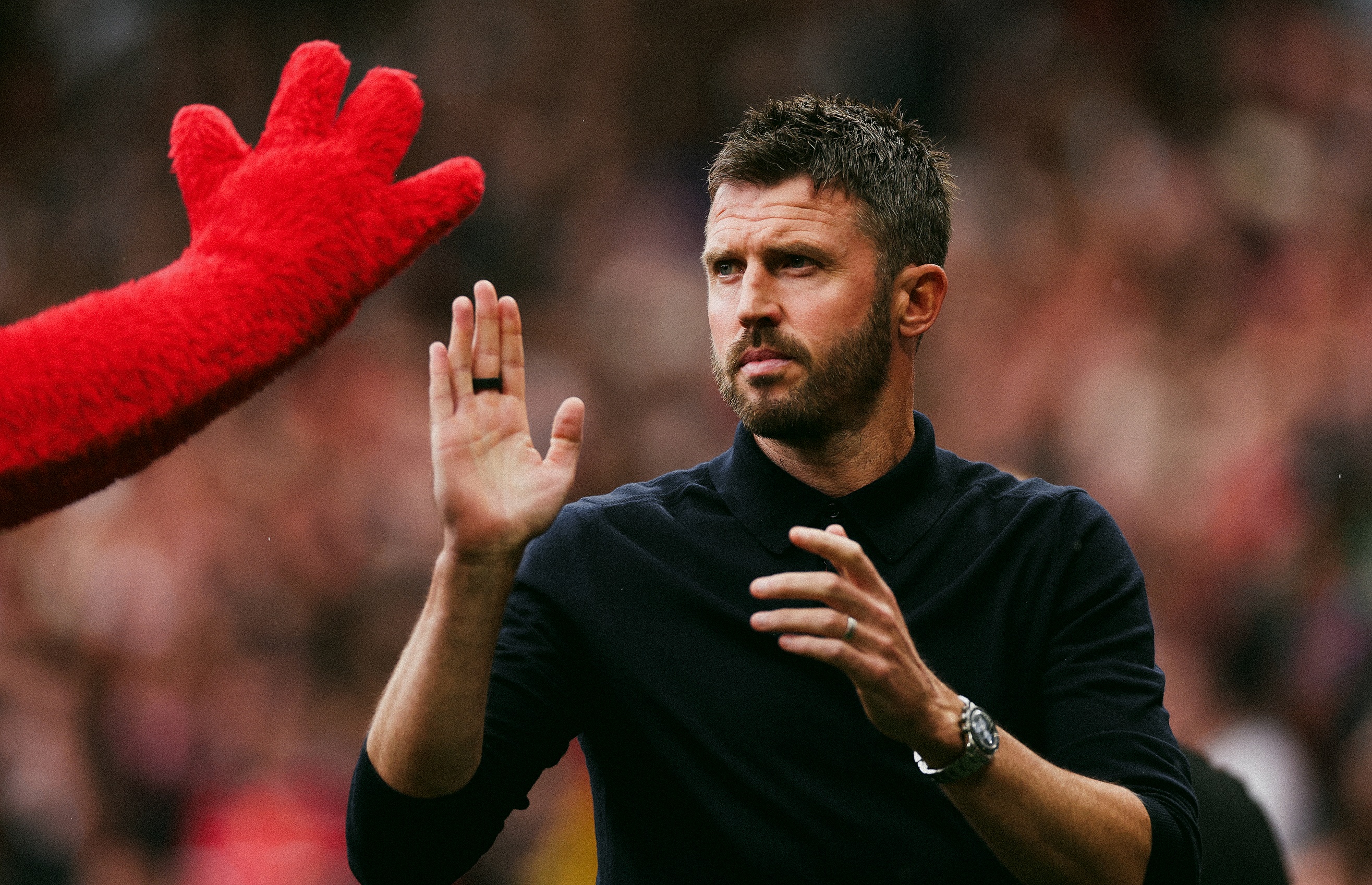 Michael Carrick high fives Manchester United mascot.