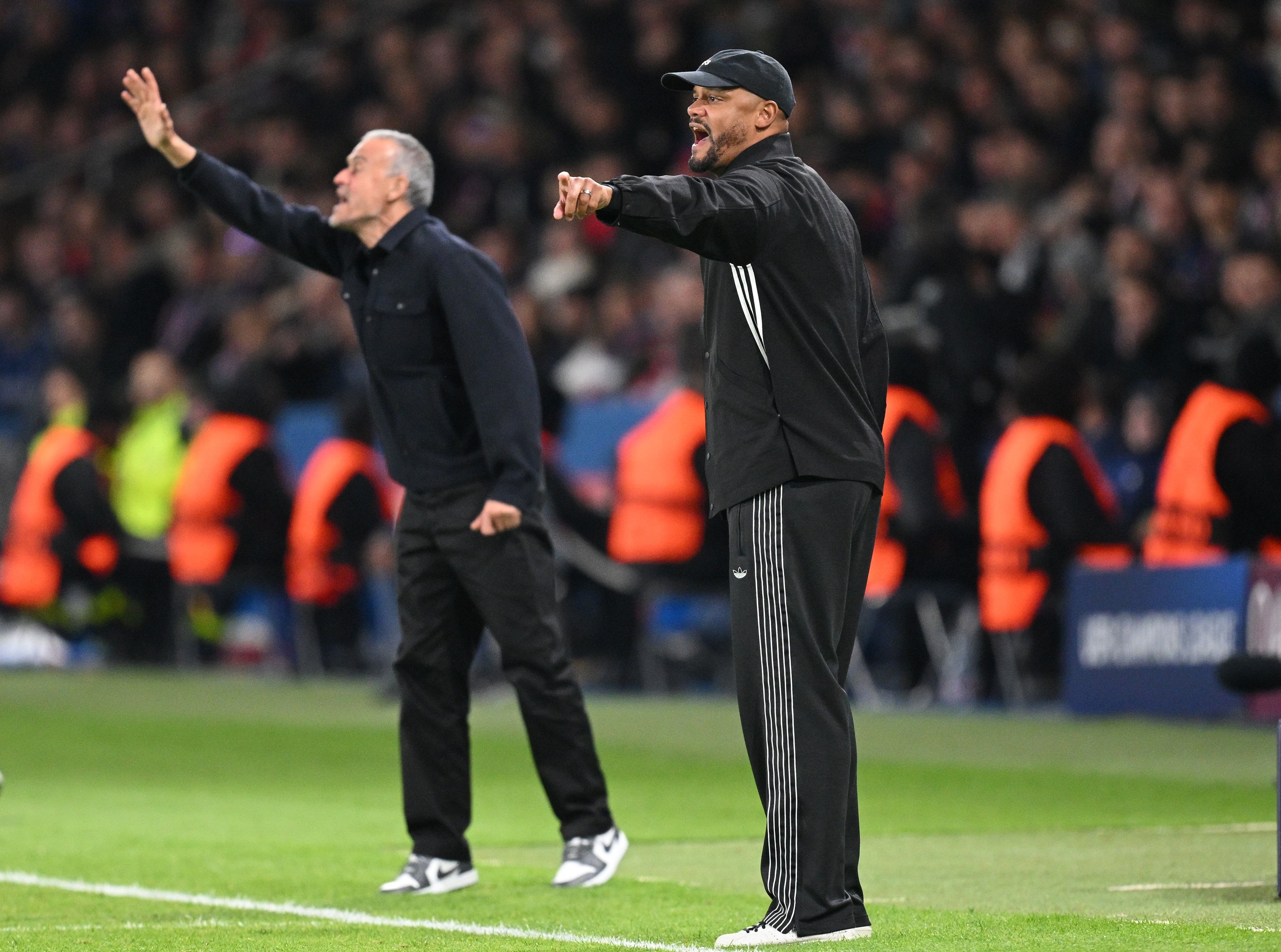 Bayern and PSG bosses Vincent Kompany and Luis Enrique shout and point their fingers from the touchline.
