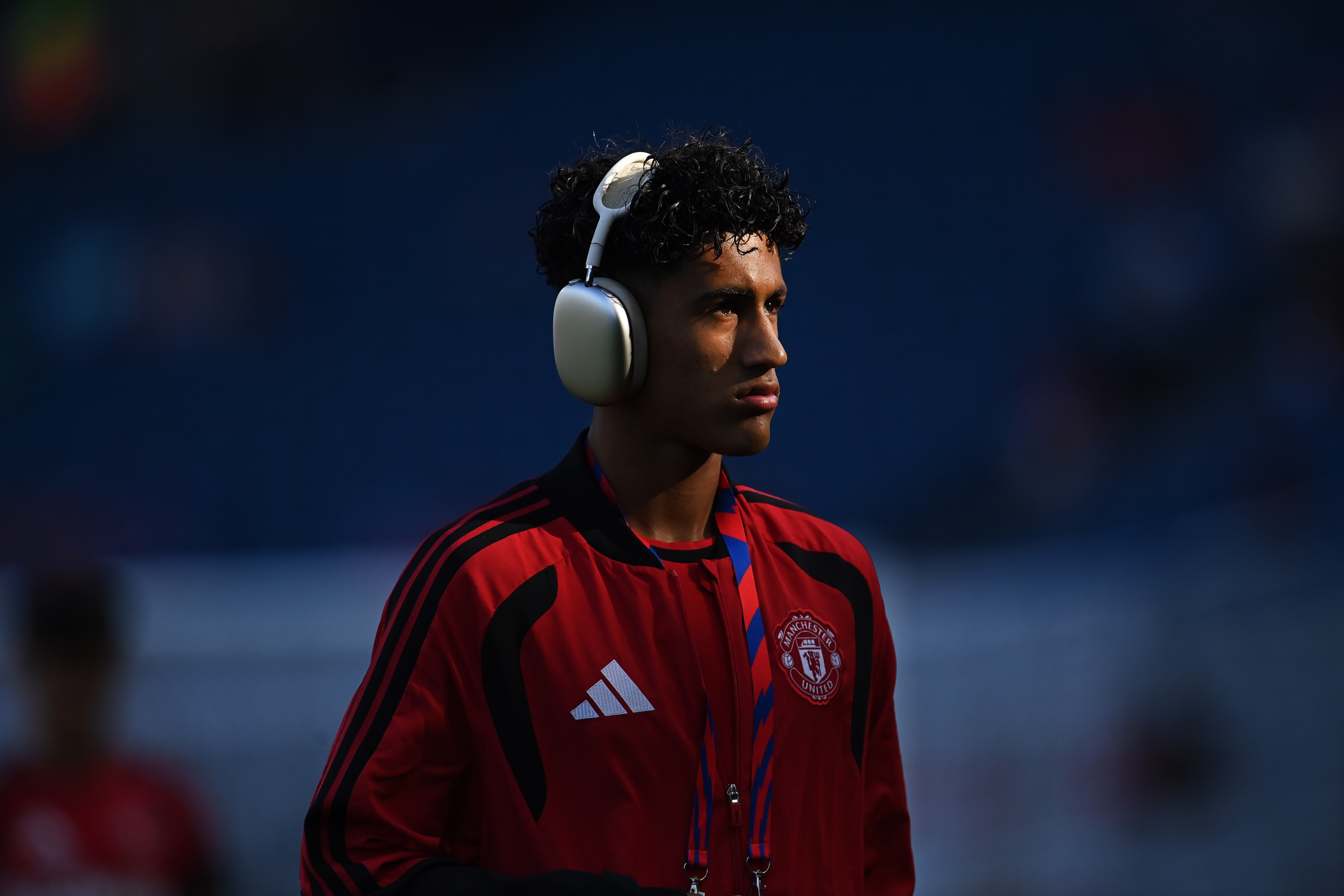 Manchester United prodigy JJ Gabriel listens to music from his over ear headphones